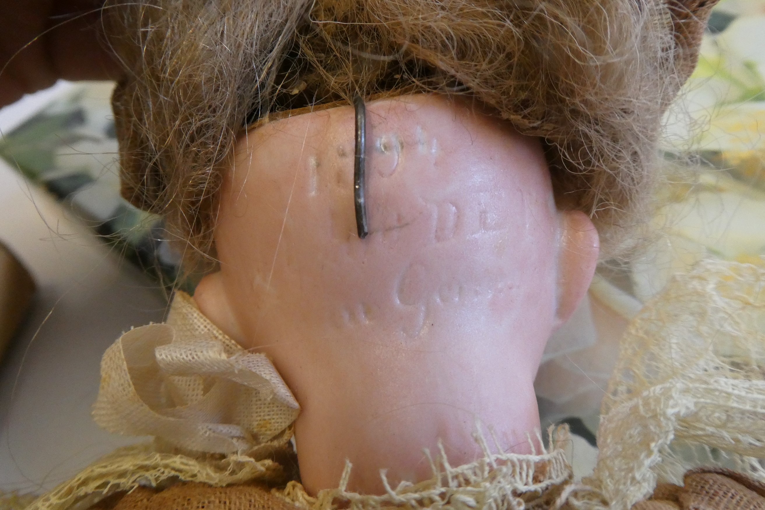 An Armand Marseille bisque socket head doll with blue glass sleeping eyes Image