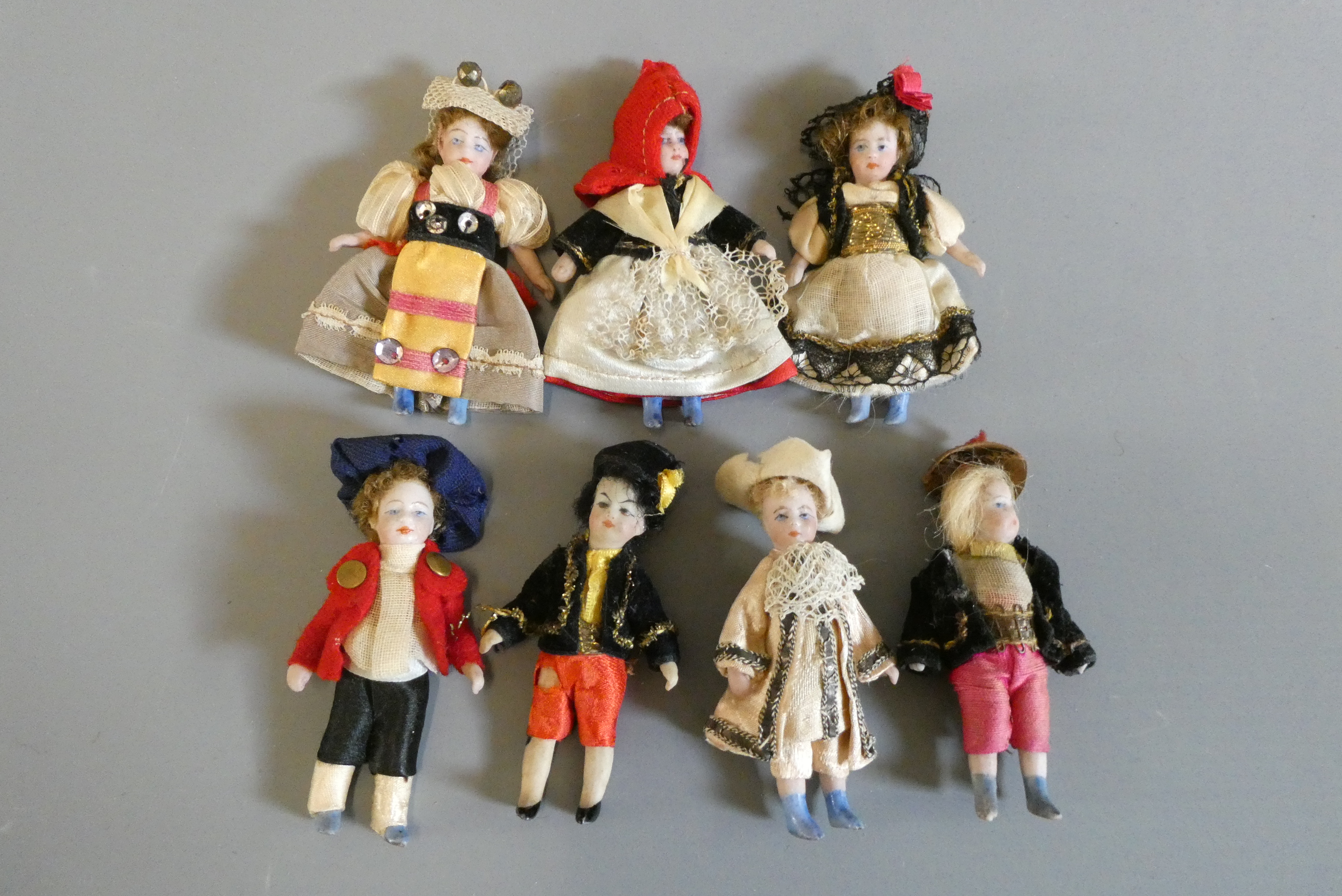 Seven all bisque doll's house dolls, all with painted features and shoes, straight legs and original Image