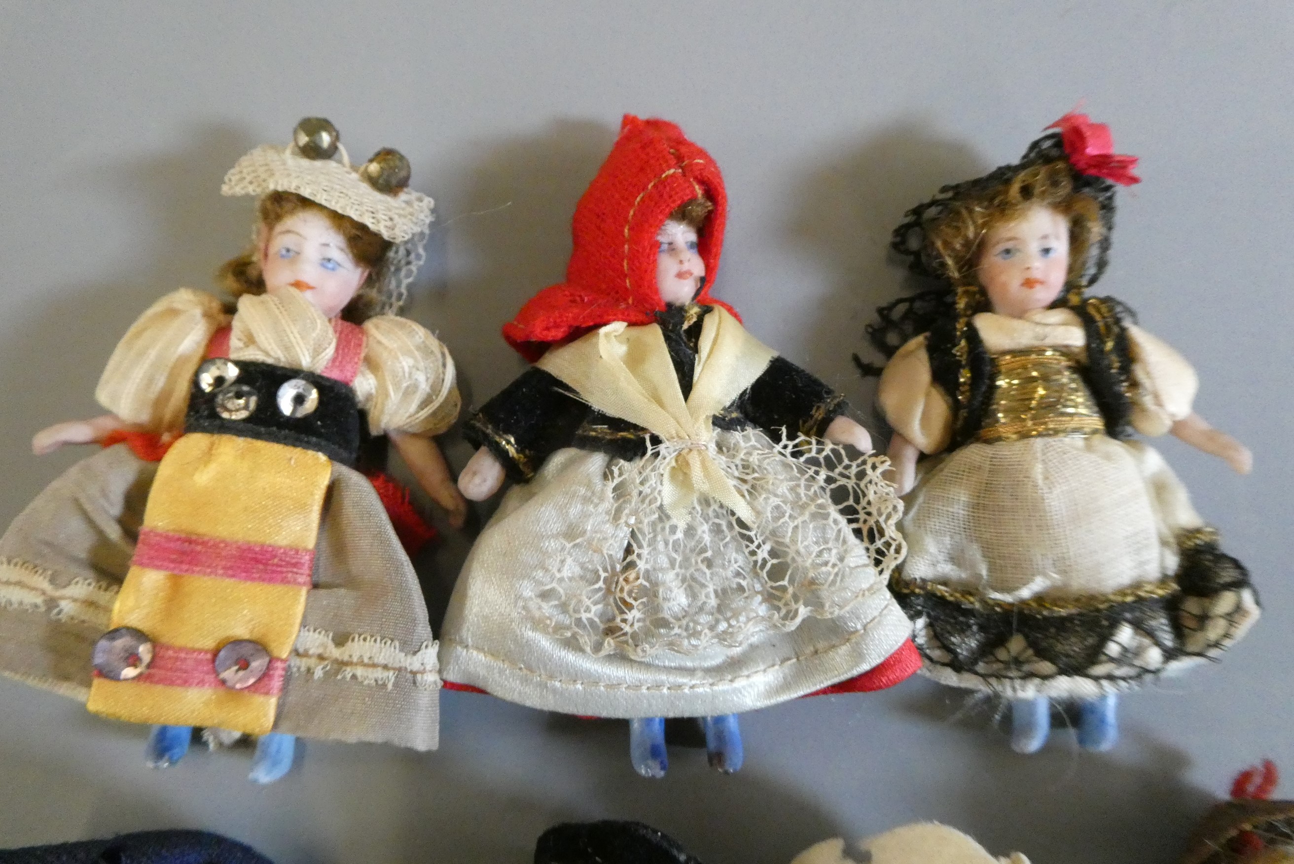 Seven all bisque doll's house dolls, all with painted features and shoes, straight legs and original Image