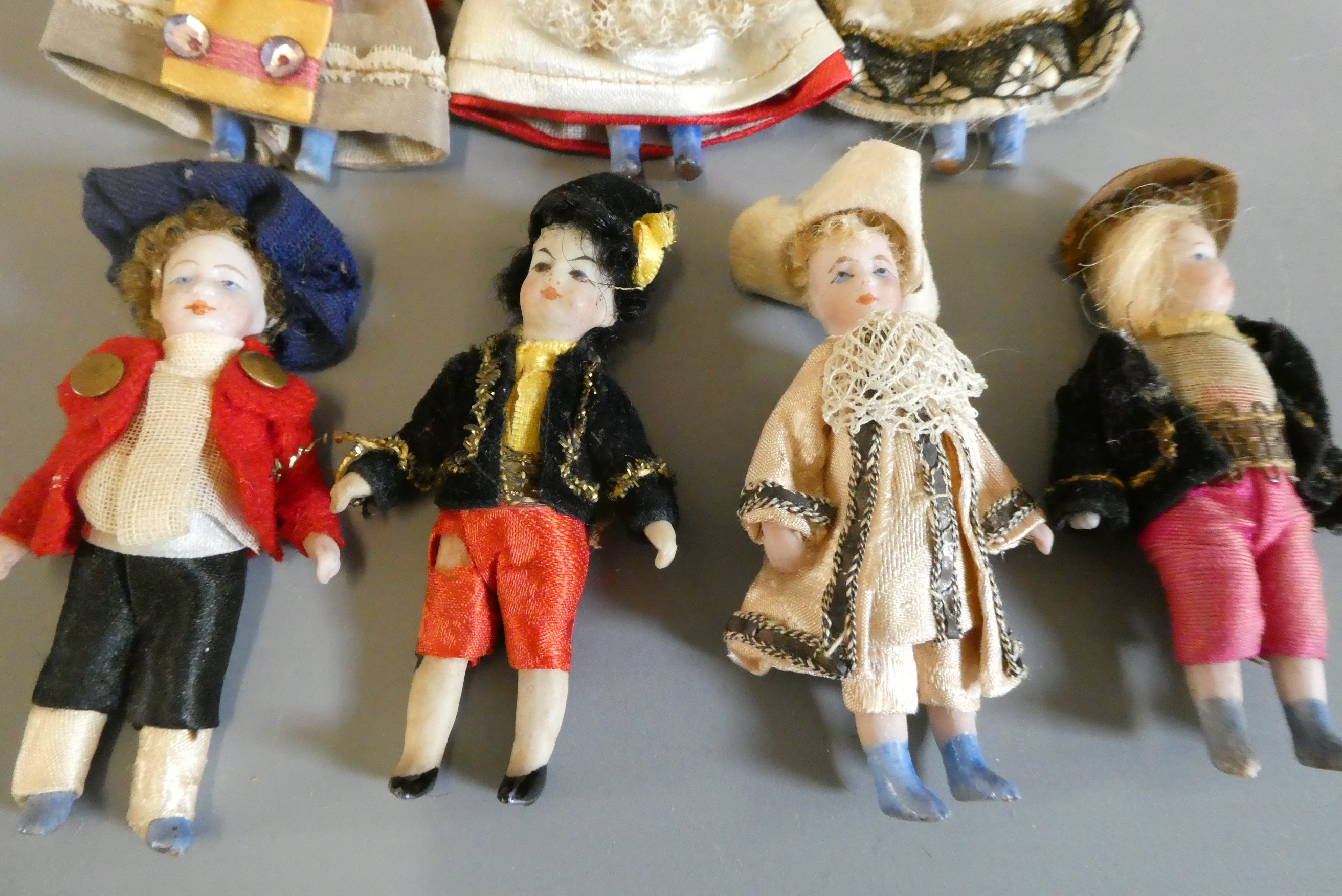 Seven all bisque doll's house dolls, all with painted features and shoes, straight legs and original Image