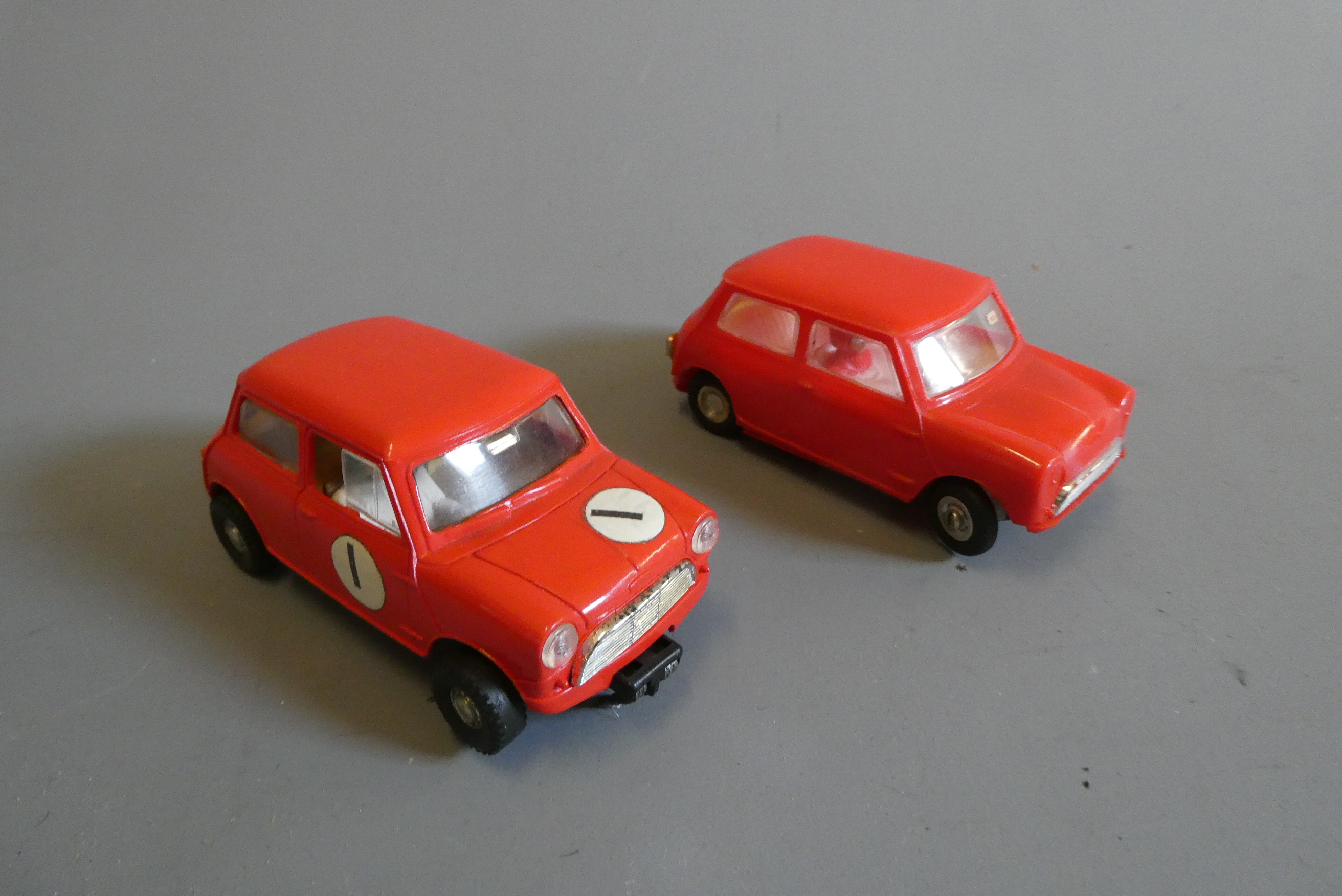 Two Airfix MRRC slot cars comprising first and late versions of the Mini Cooper in red, good (Est. Image