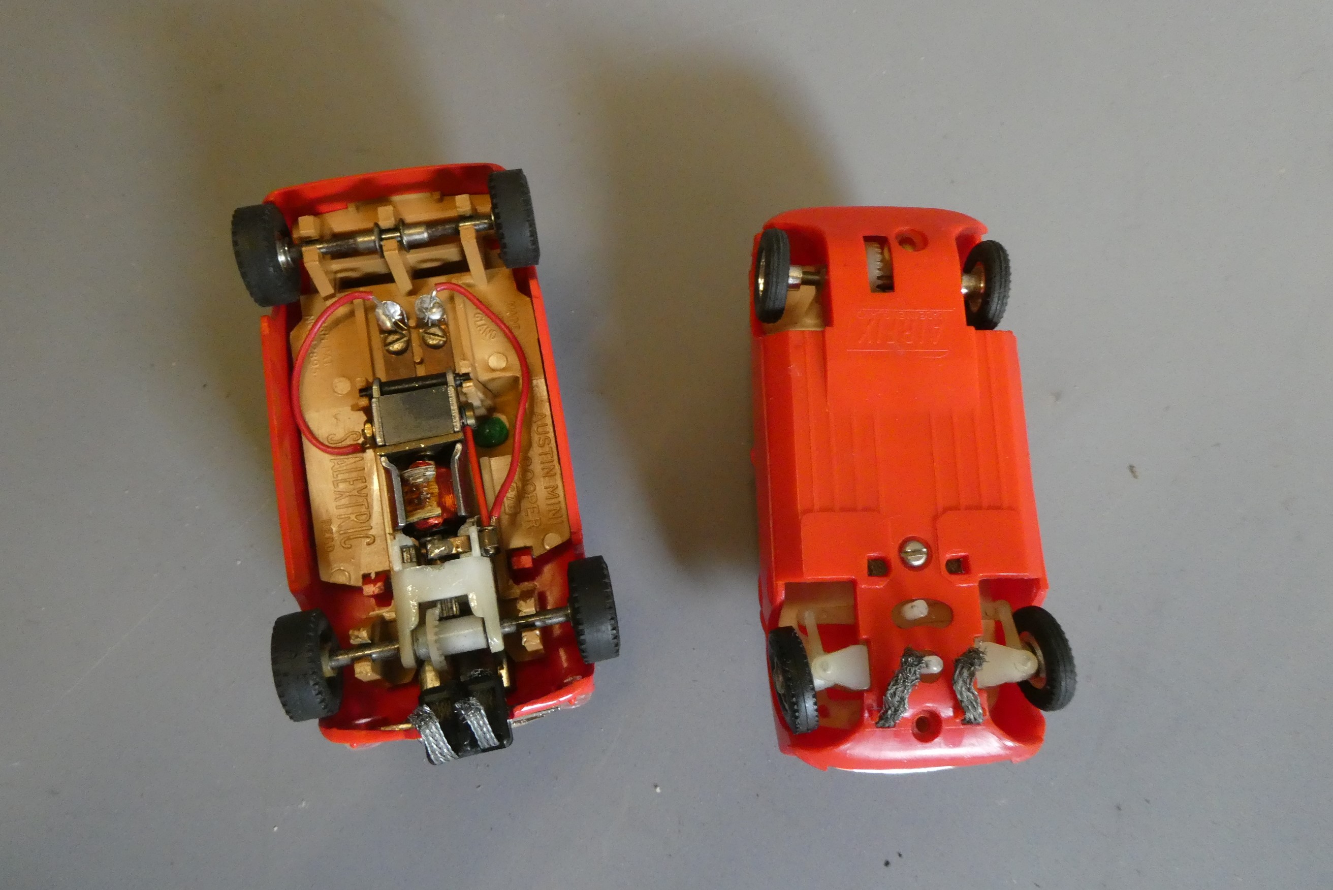 Two Airfix MRRC slot cars comprising first and late versions of the Mini Cooper in red, good (Est. Image