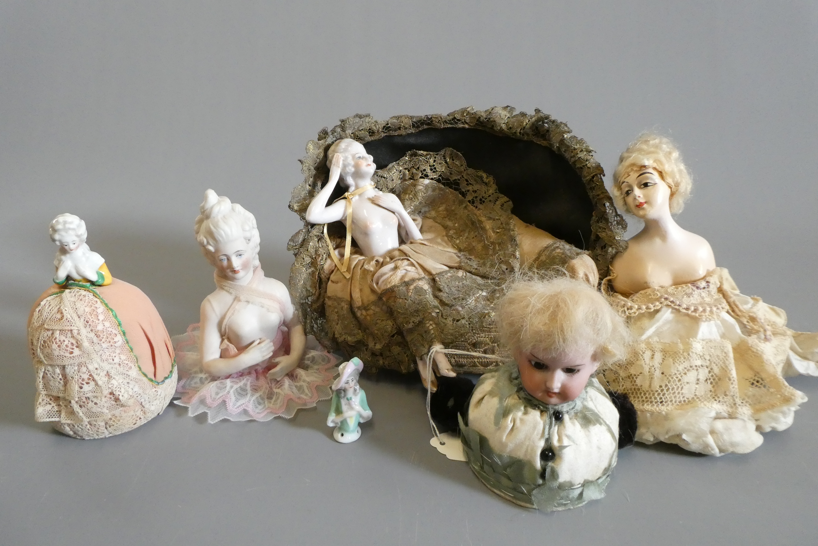 Four pin cushion and two fashion dolls Image