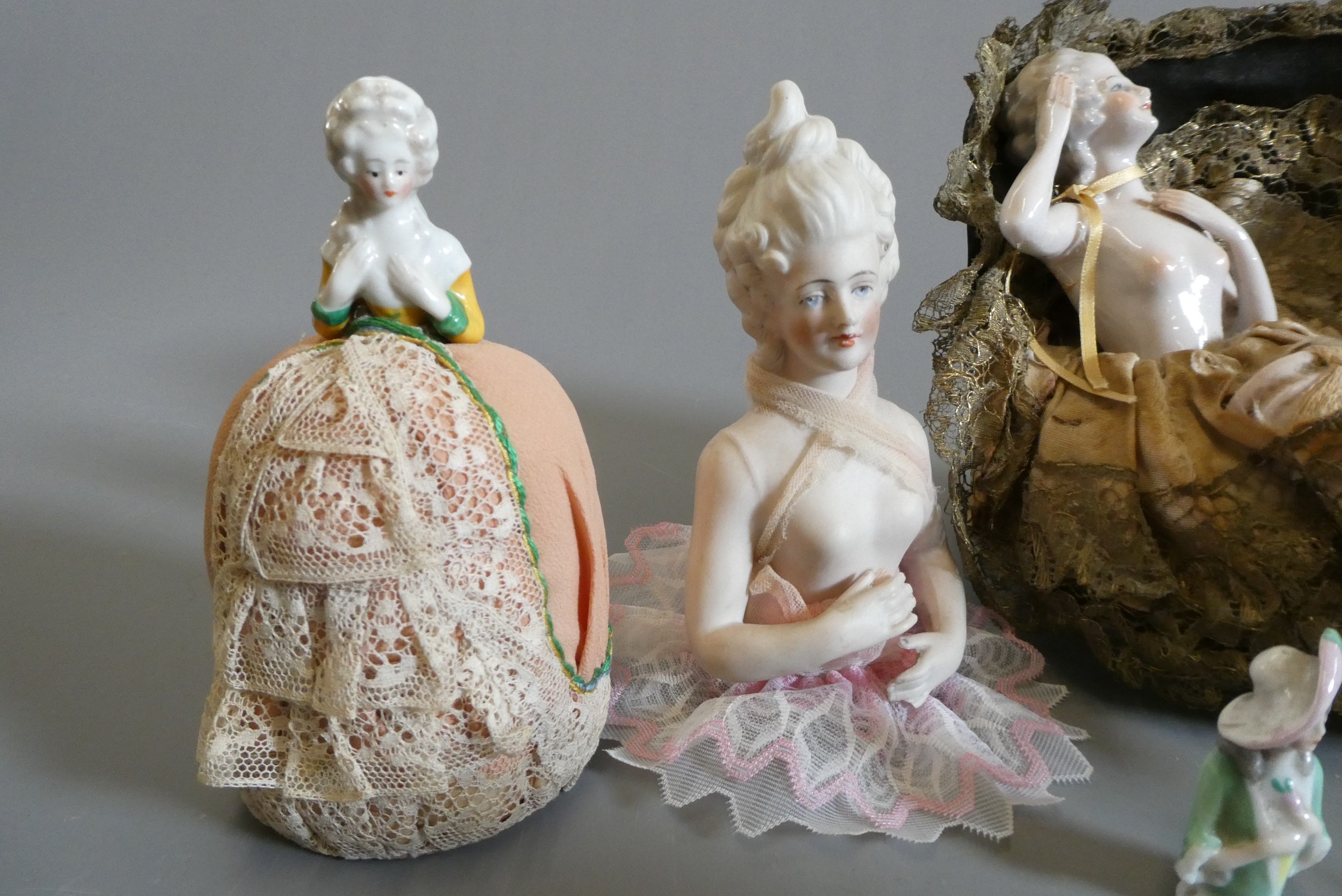 Four pin cushion and two fashion dolls Image