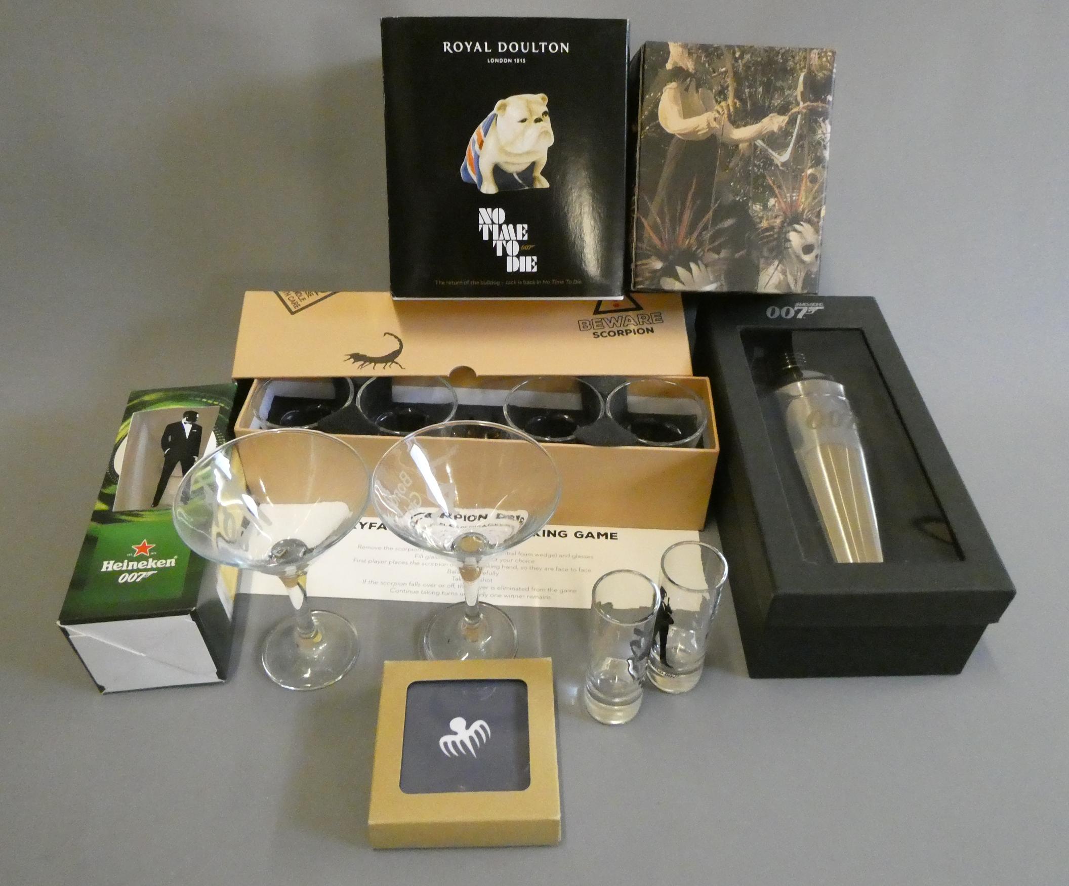 James Bond themed glasses and drink related items including shot glasses Image
