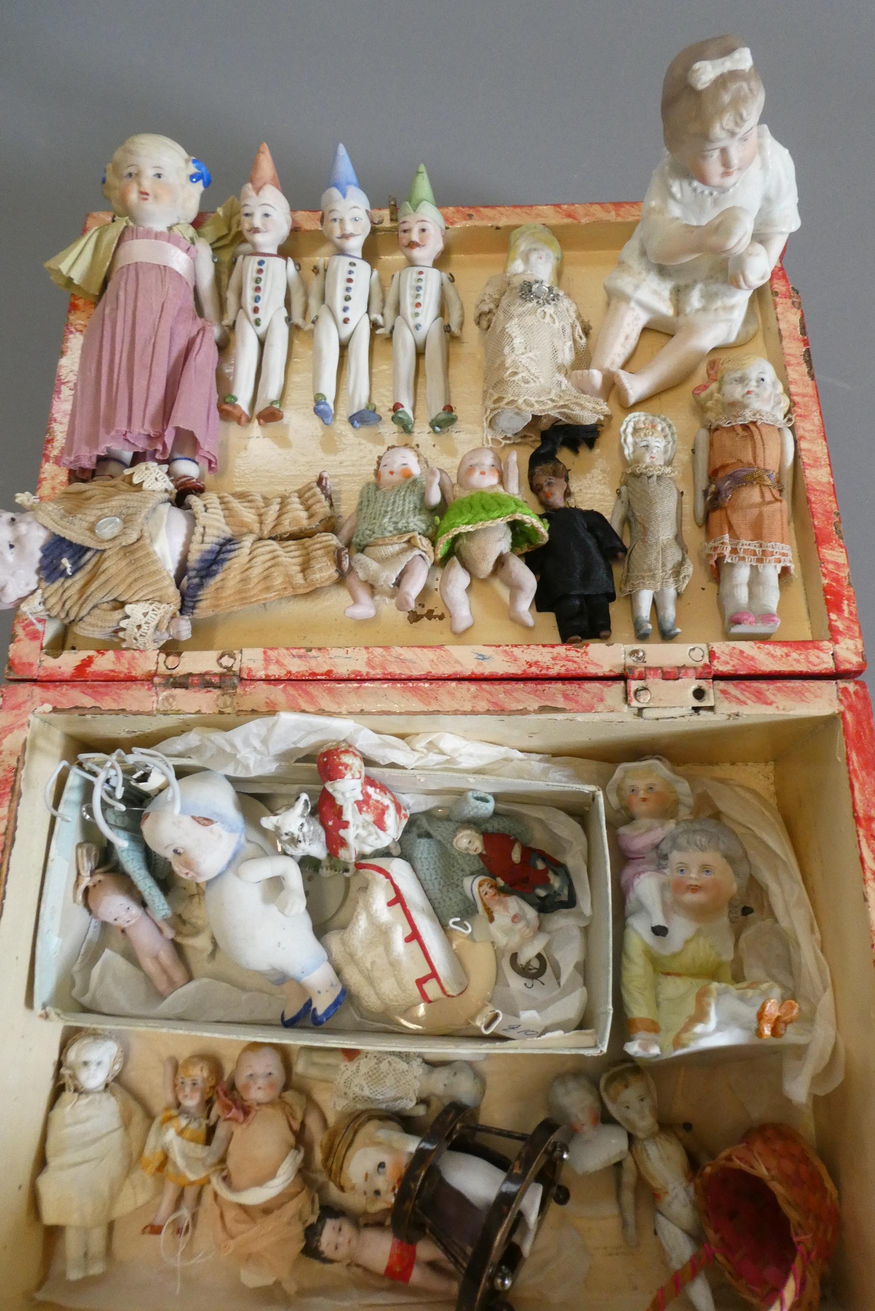 A chest of doll's house and miniature dolls and models, mainly bisque, including three jointed Image