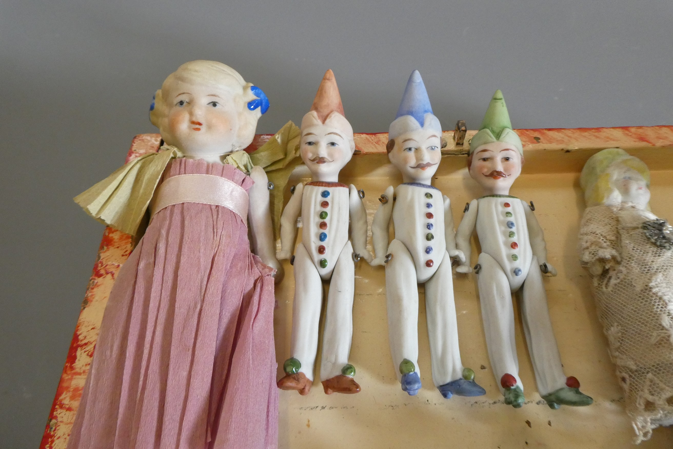 A chest of doll's house and miniature dolls and models, mainly bisque, including three jointed Image