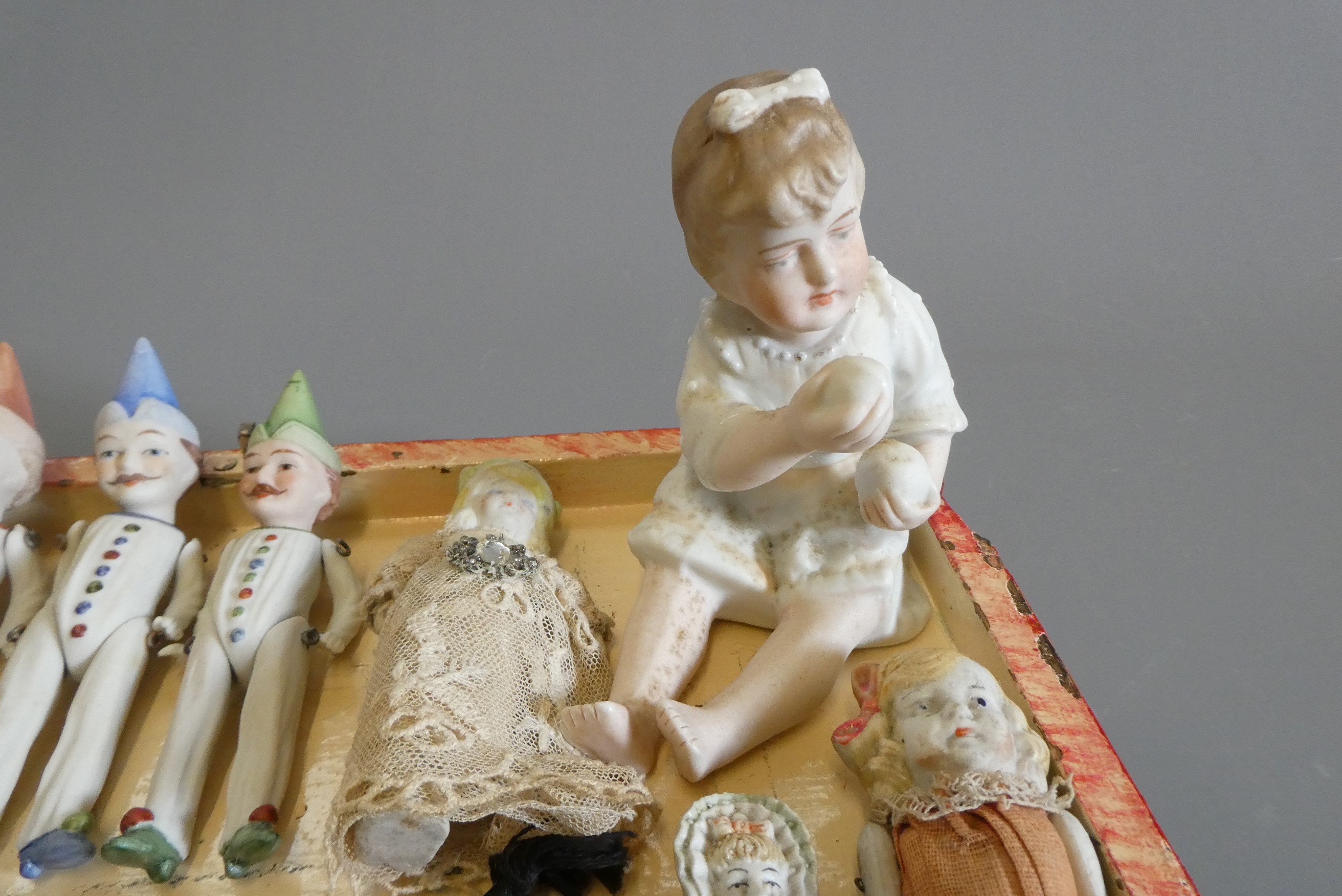 A chest of doll's house and miniature dolls and models, mainly bisque, including three jointed Image