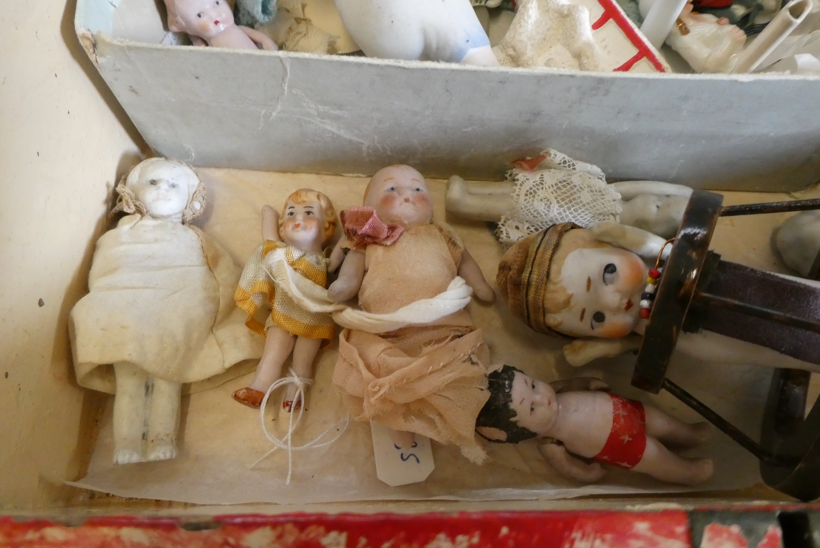 A chest of doll's house and miniature dolls and models, mainly bisque, including three jointed Image