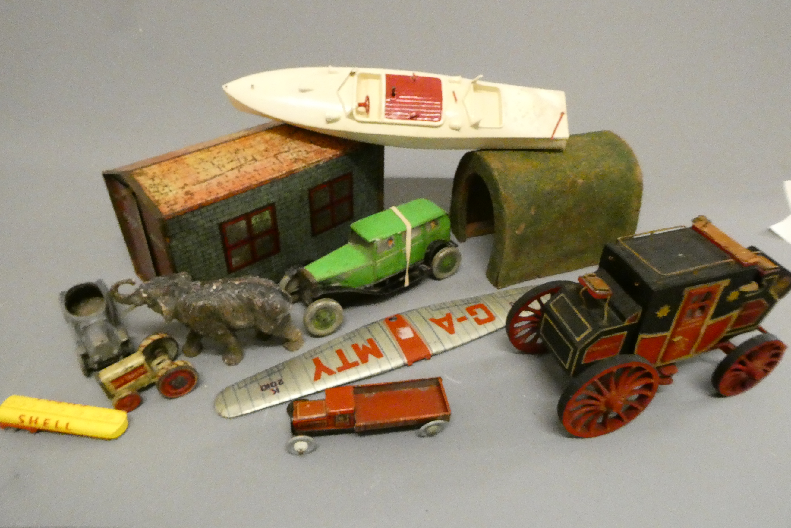 Assorted tinplate and wooden toys including tinplate garage, tin saloon car, wooden tunnel and Image