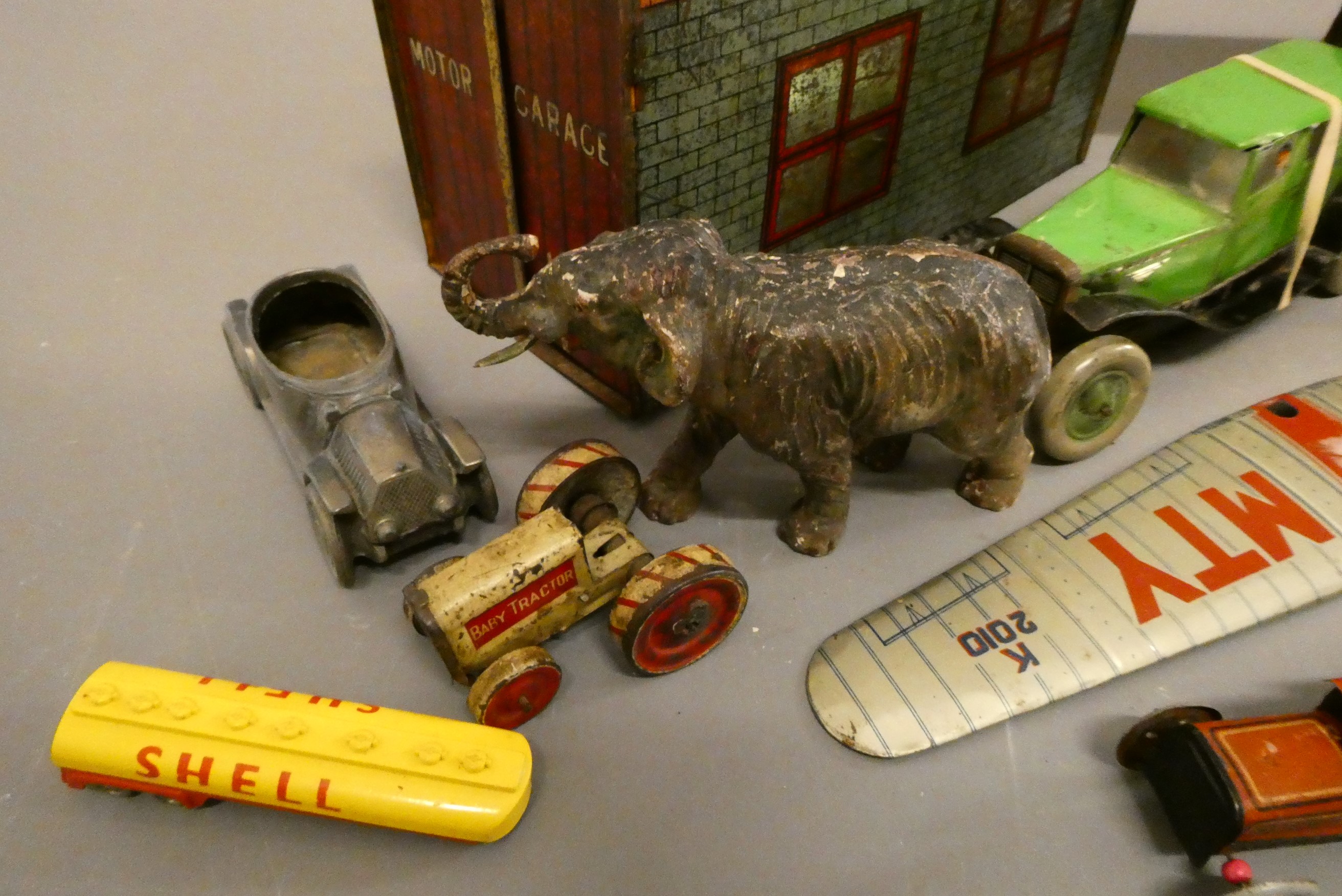 Assorted tinplate and wooden toys including tinplate garage, tin saloon car, wooden tunnel and Image