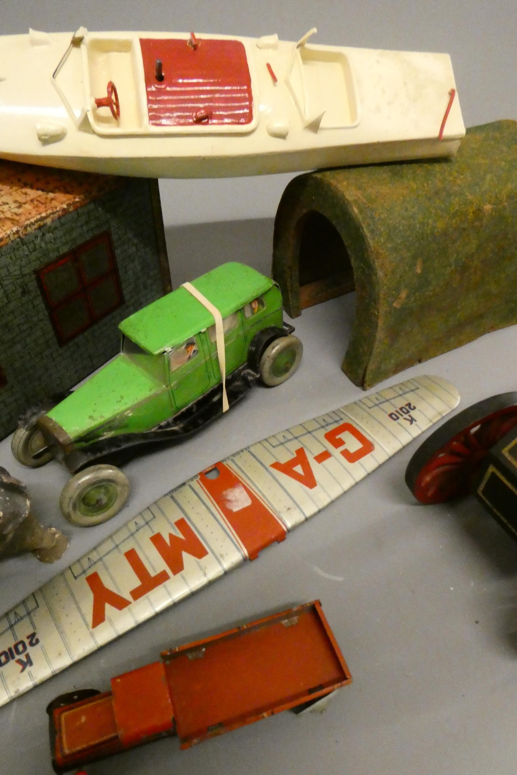 Assorted tinplate and wooden toys including tinplate garage, tin saloon car, wooden tunnel and Image