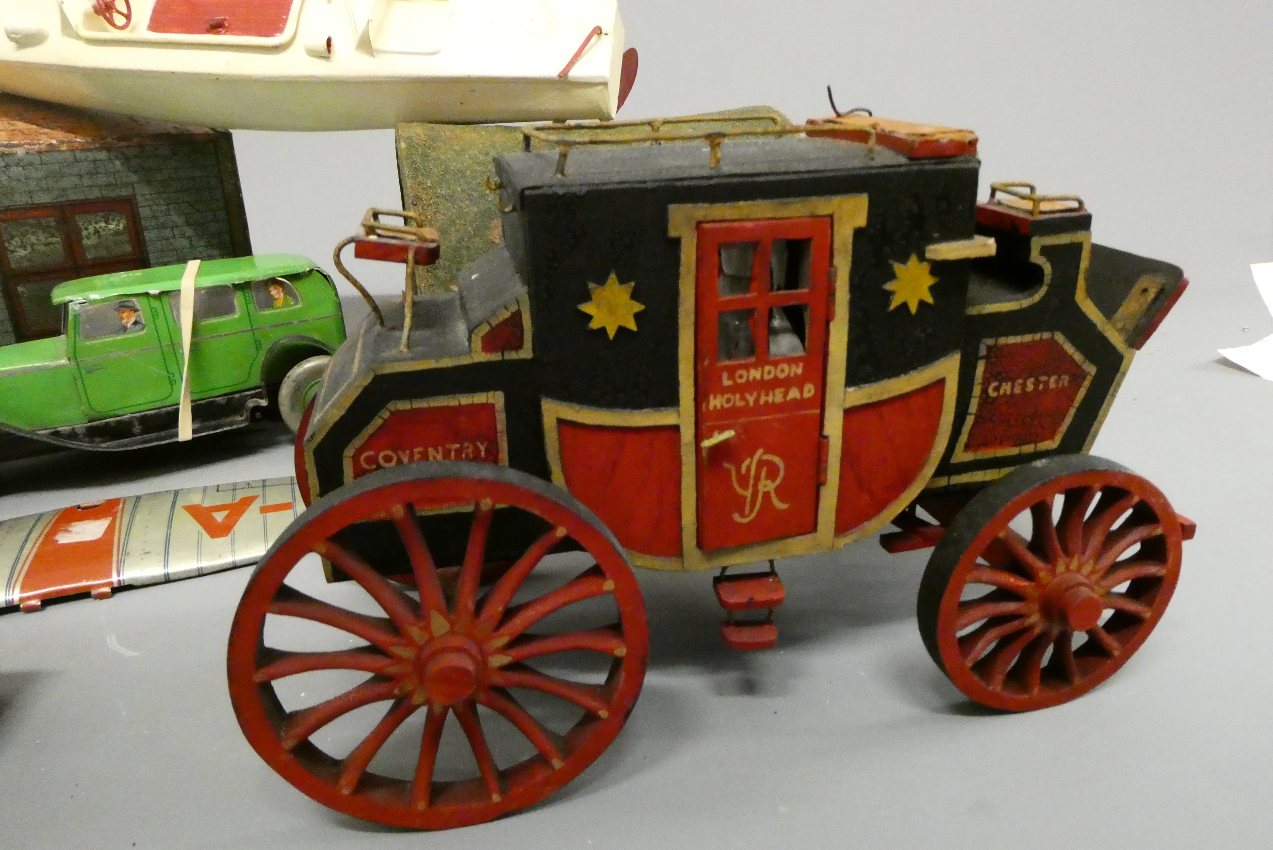 Assorted tinplate and wooden toys including tinplate garage, tin saloon car, wooden tunnel and Image