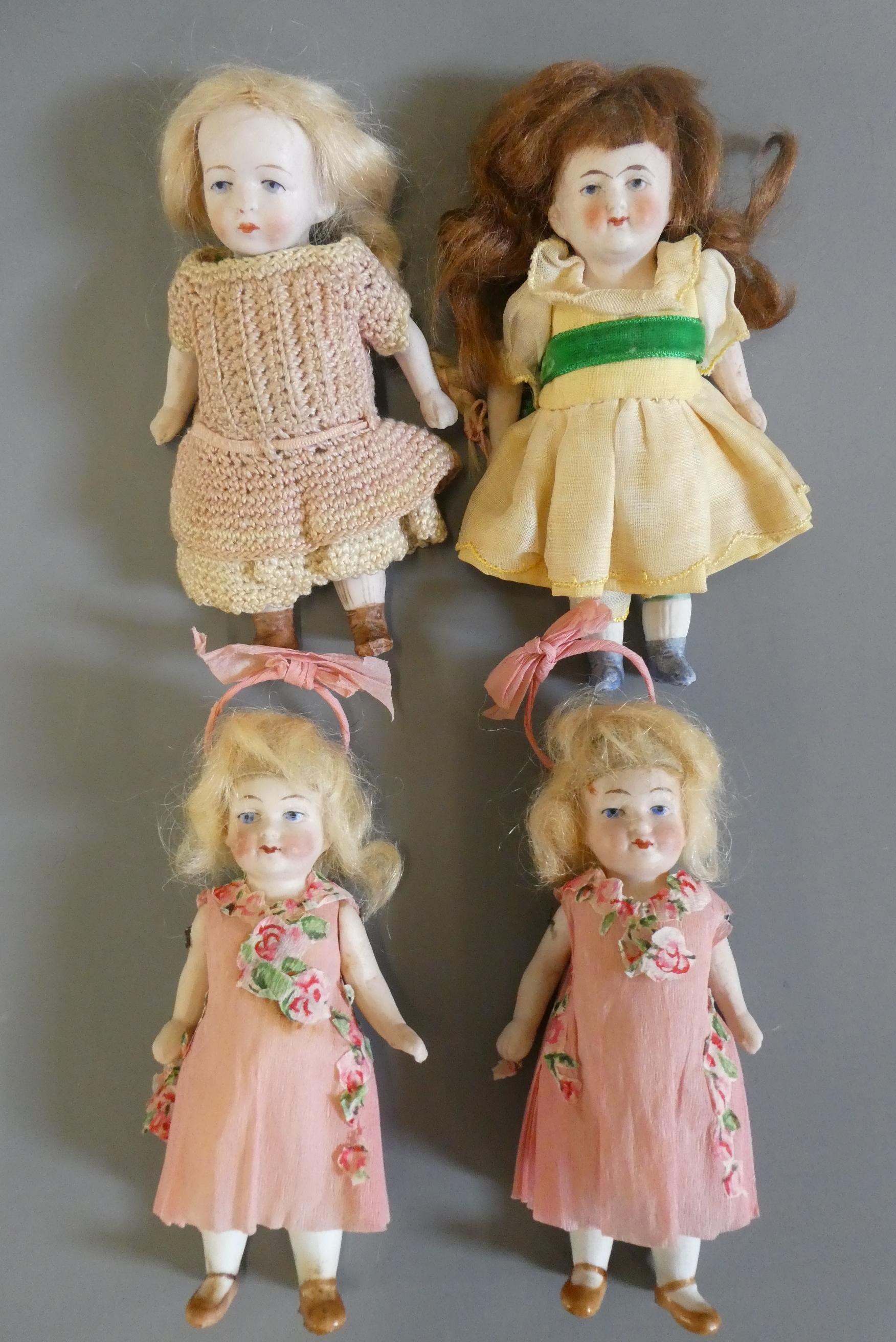 Four all bisque doll's house dolls all with jointed shoulders and hips Image