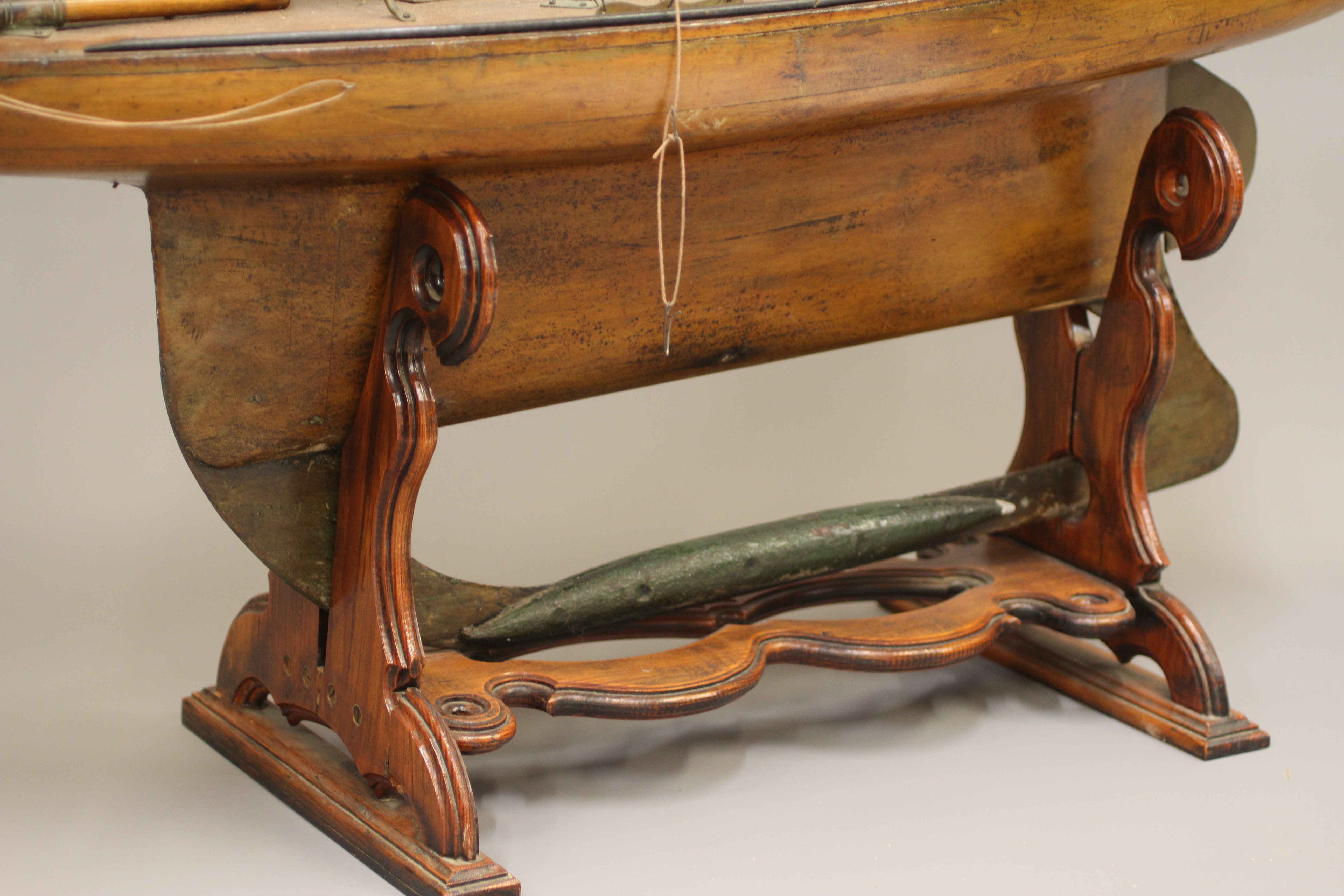 A large wooden yacht model fitted with main sail Image