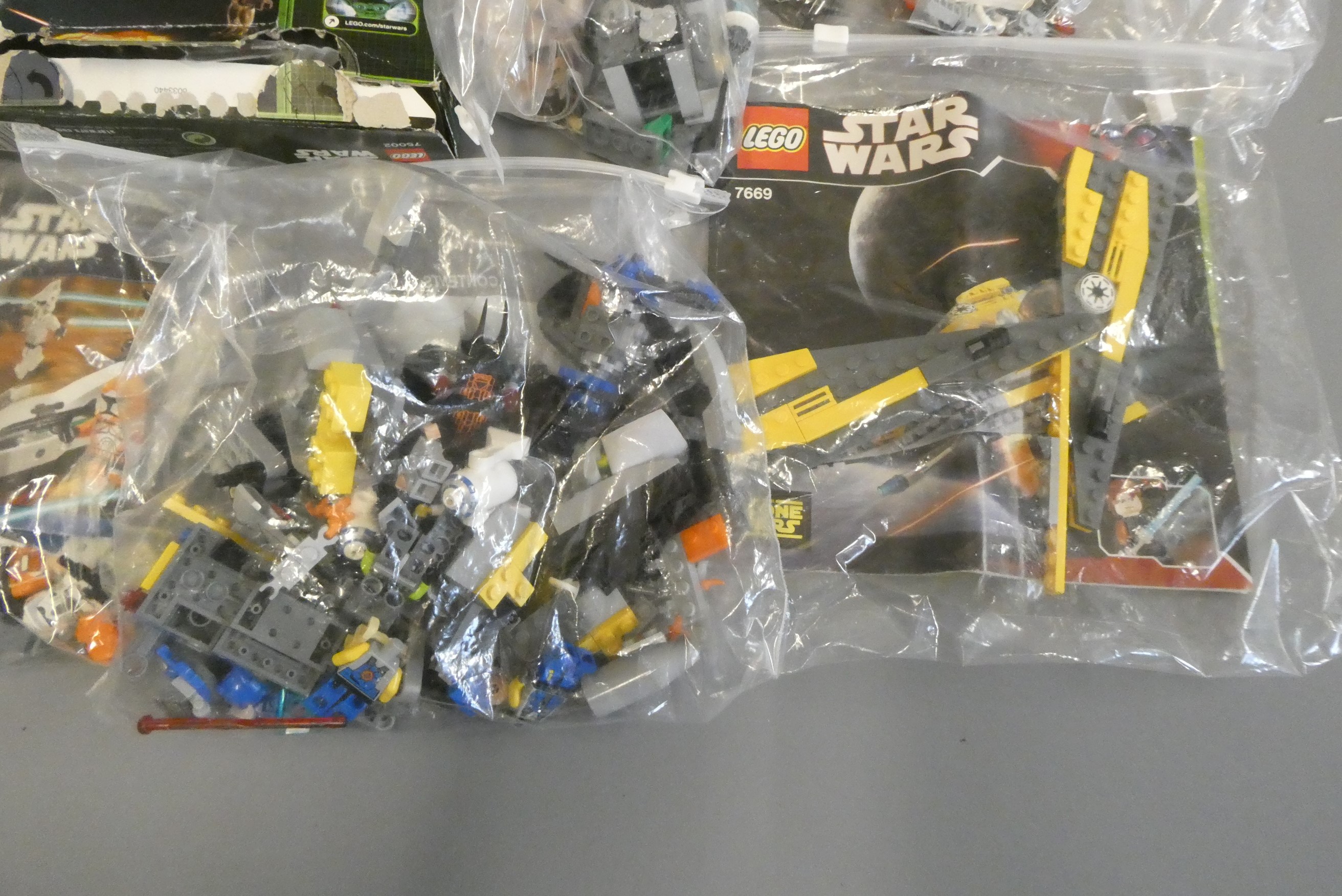 A quantity of boxed and loose Star Wars Lego including 75002 and 7914 boxed Image