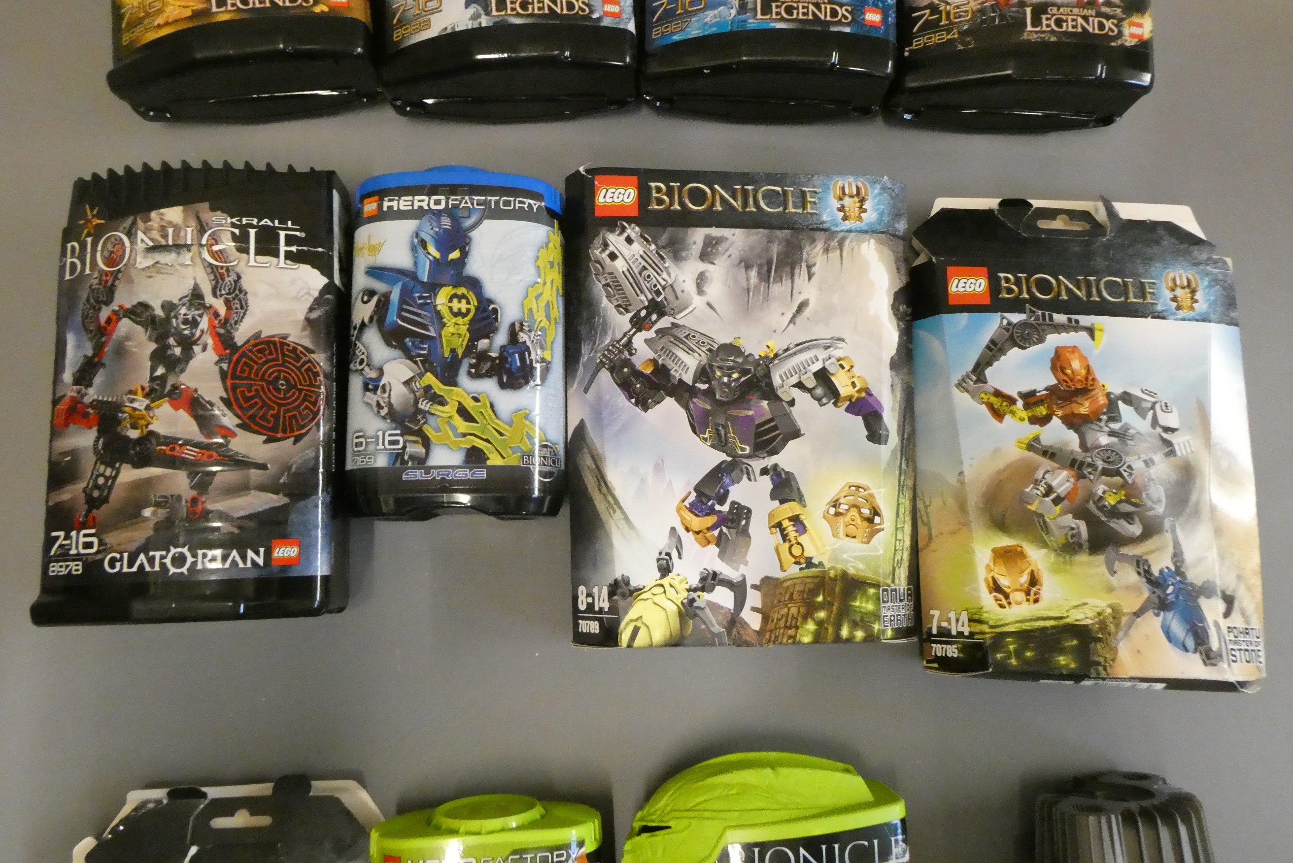 A collection of 12x boxed Lego Bionicle sets including Glatorian Legends examples Image