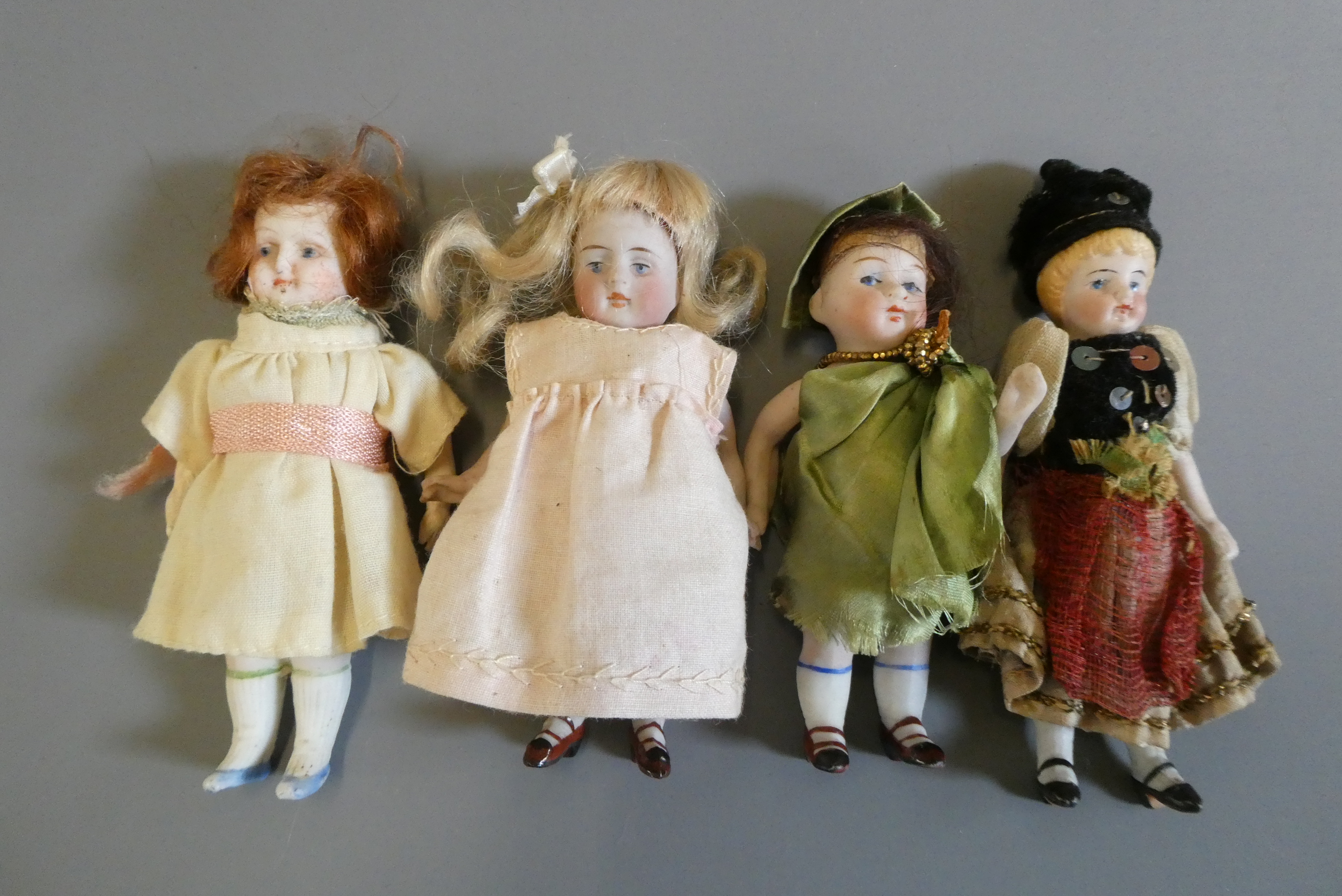 Four all bisque doll's house dolls Image