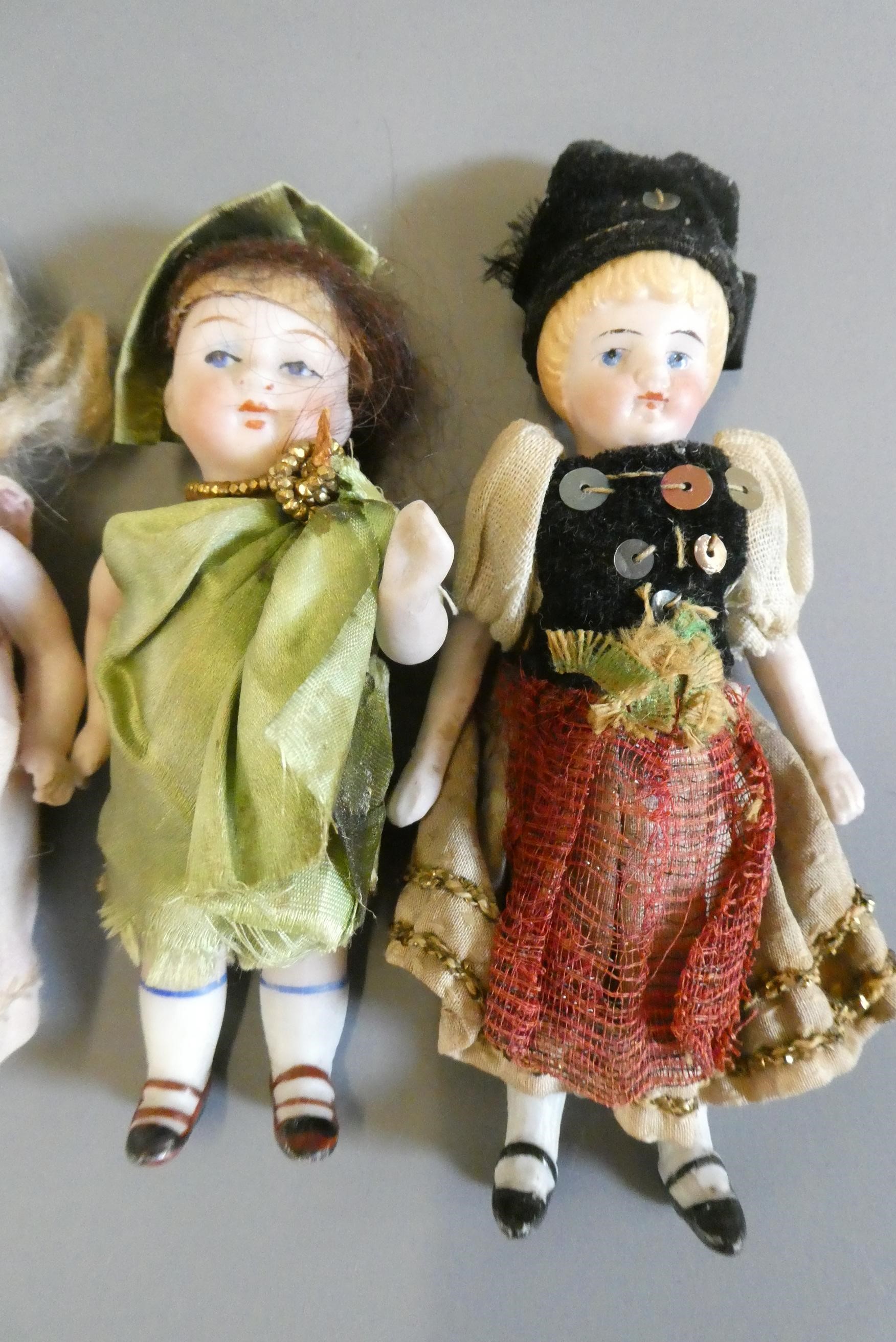 Four all bisque doll's house dolls Image