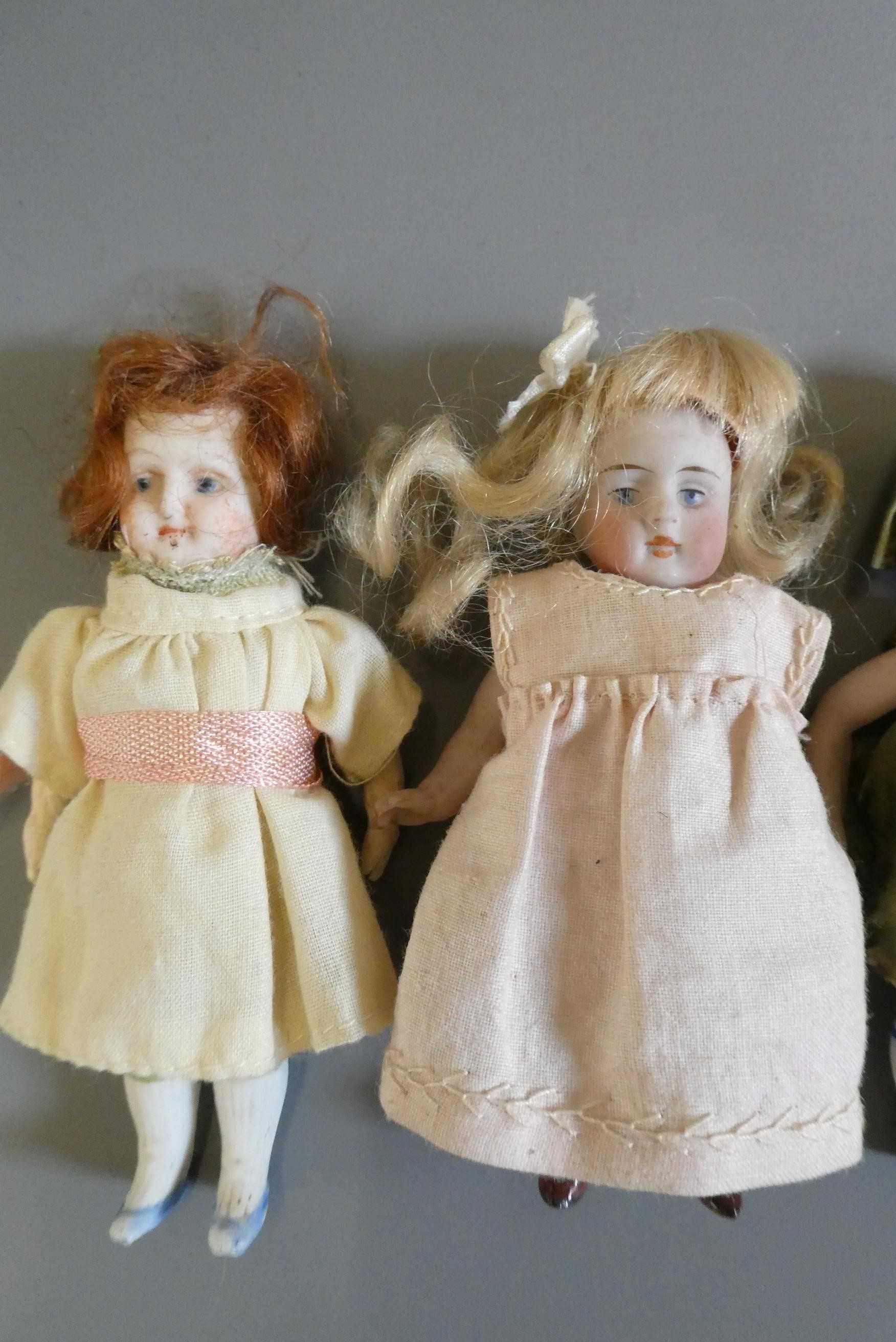 Four all bisque doll's house dolls Image