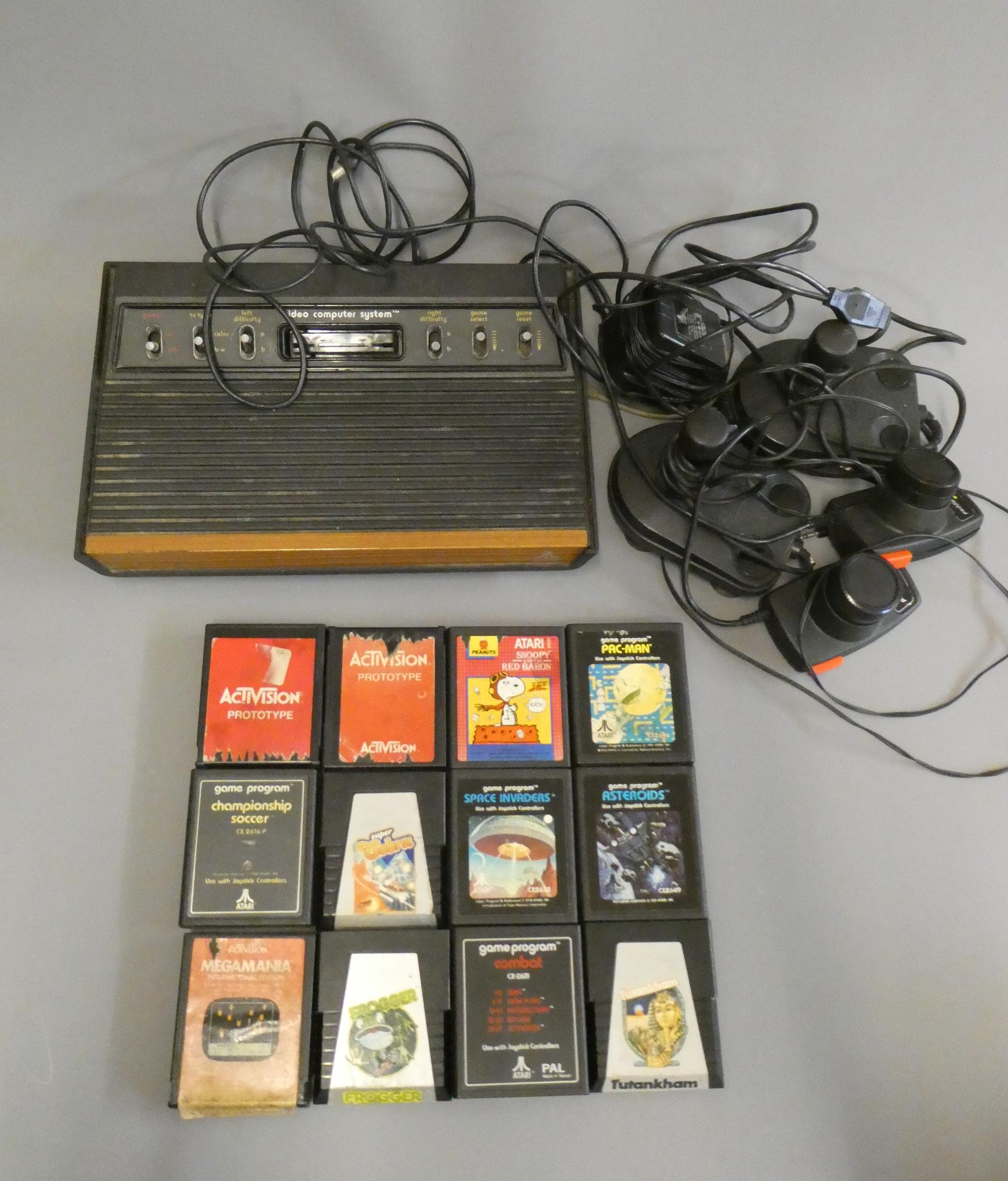 Atari video computer system with two joysticks and two paddles, together with twelve Atari Image
