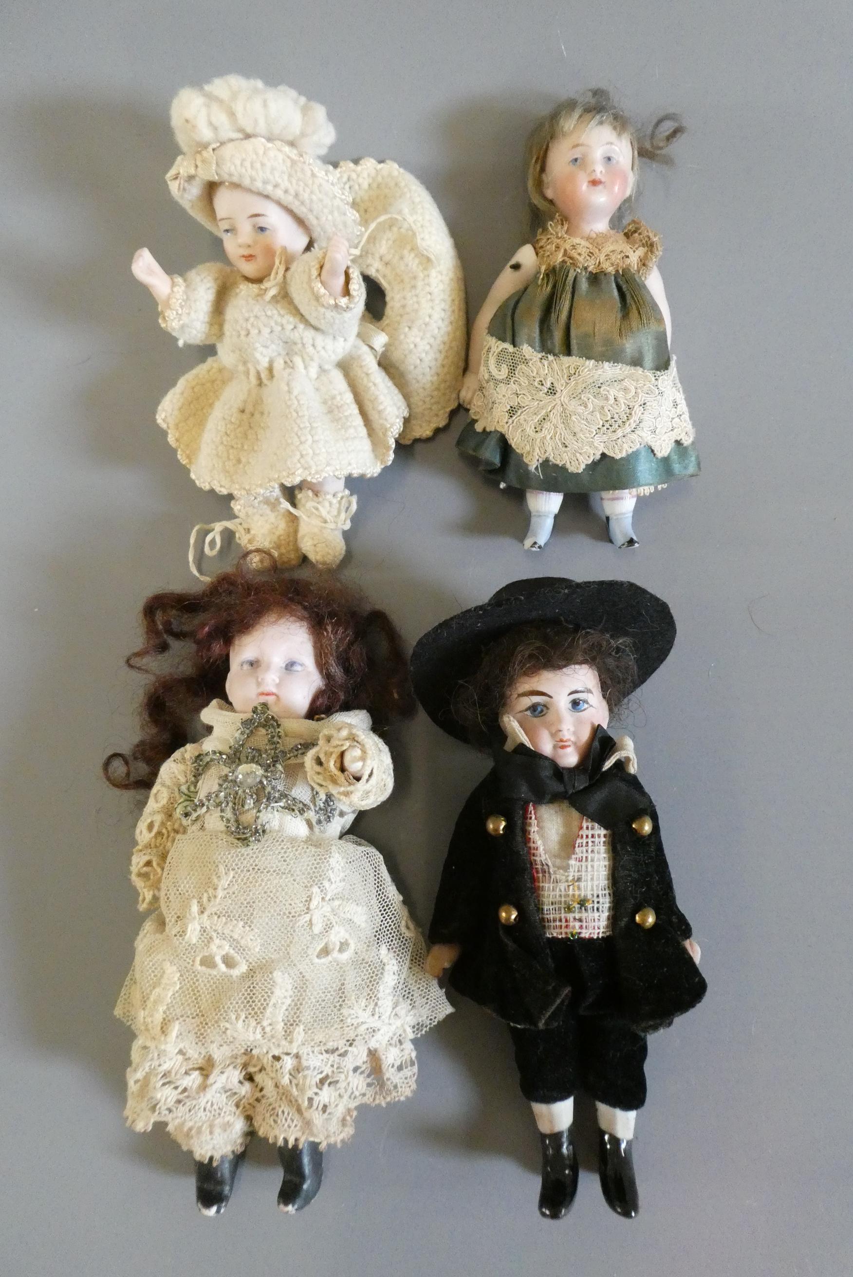 Four all bisque doll's house dolls Image