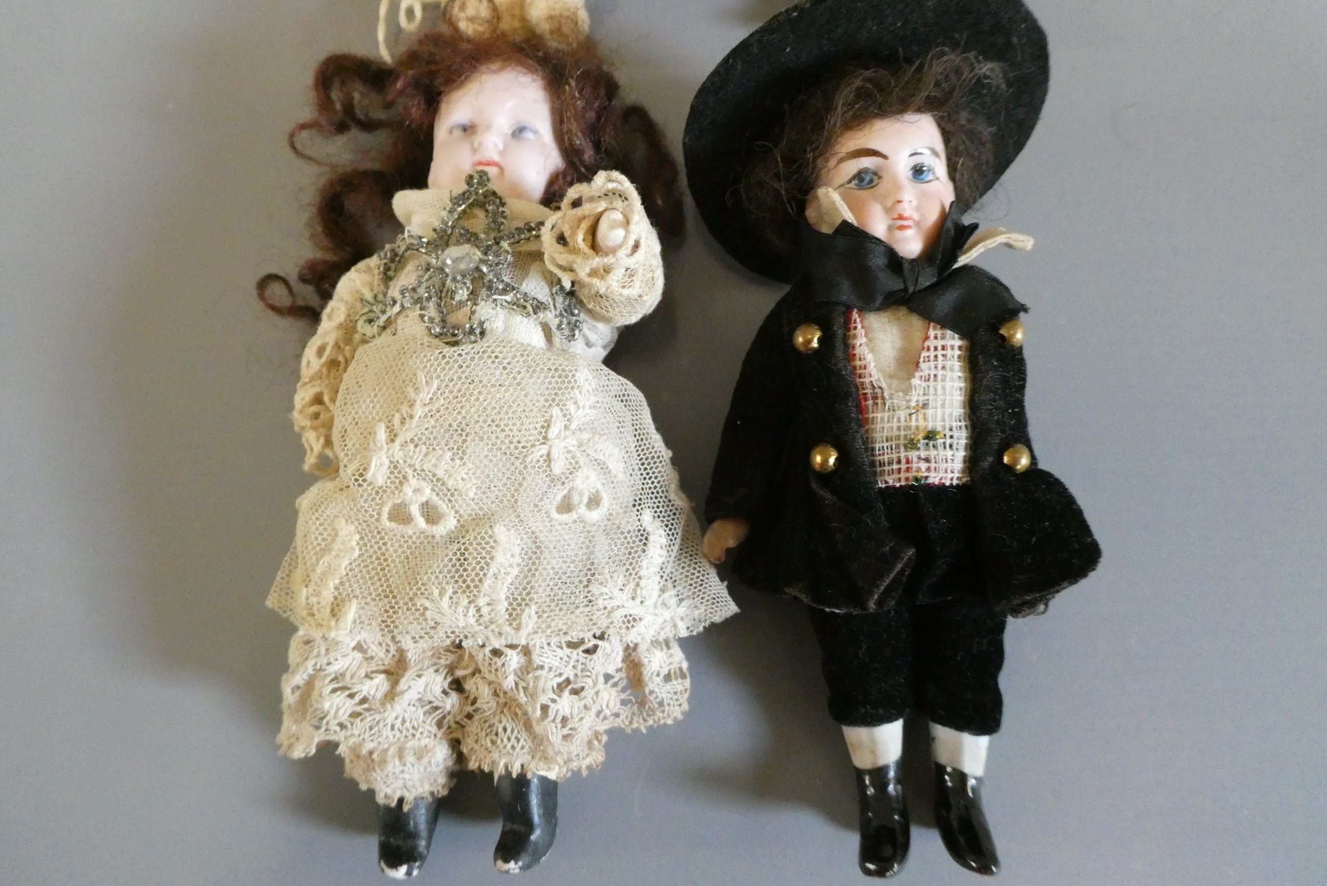 Four all bisque doll's house dolls Image