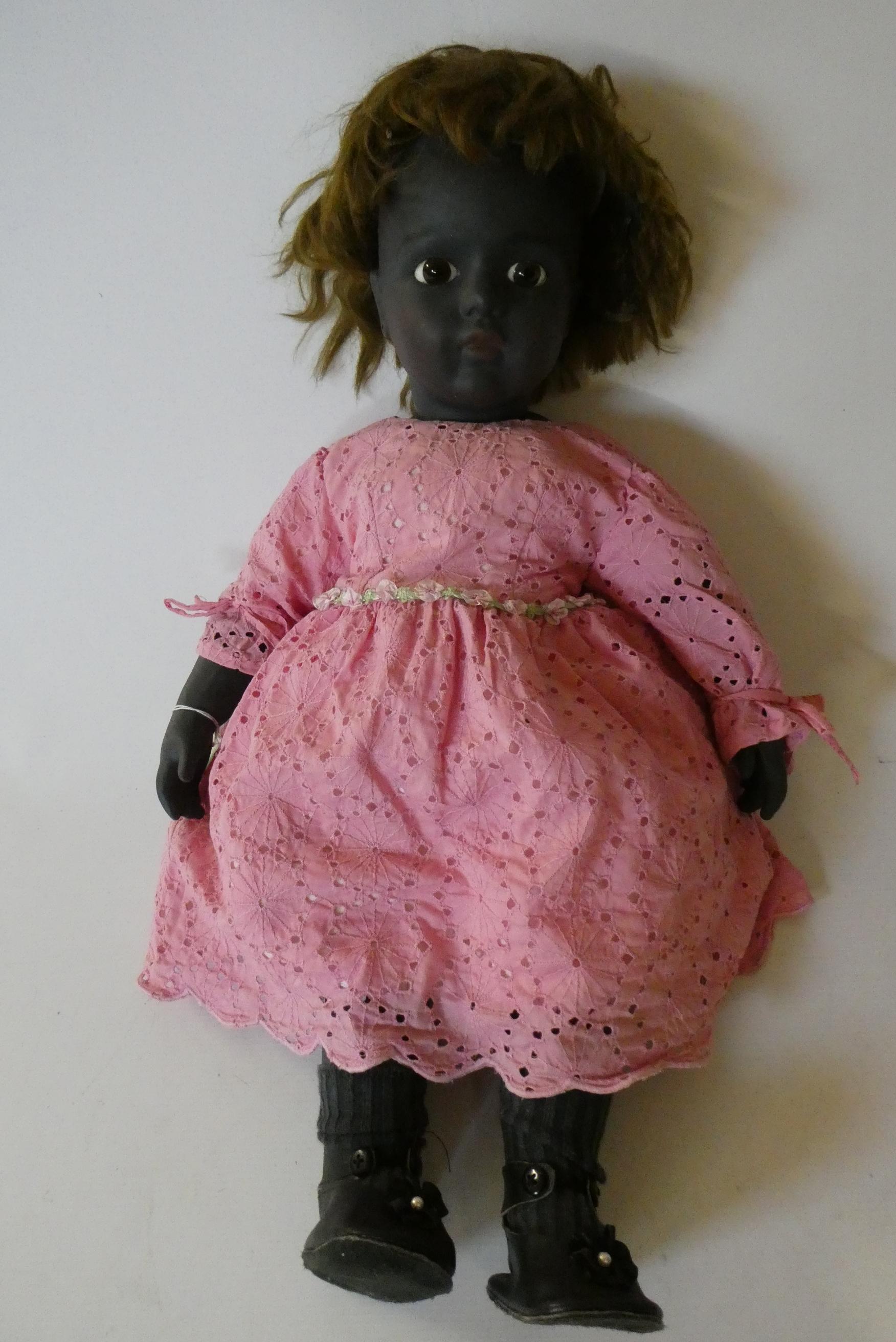 A reproduction Bru bisque socket shoulder head girl doll with brown glass fixed eyes Image
