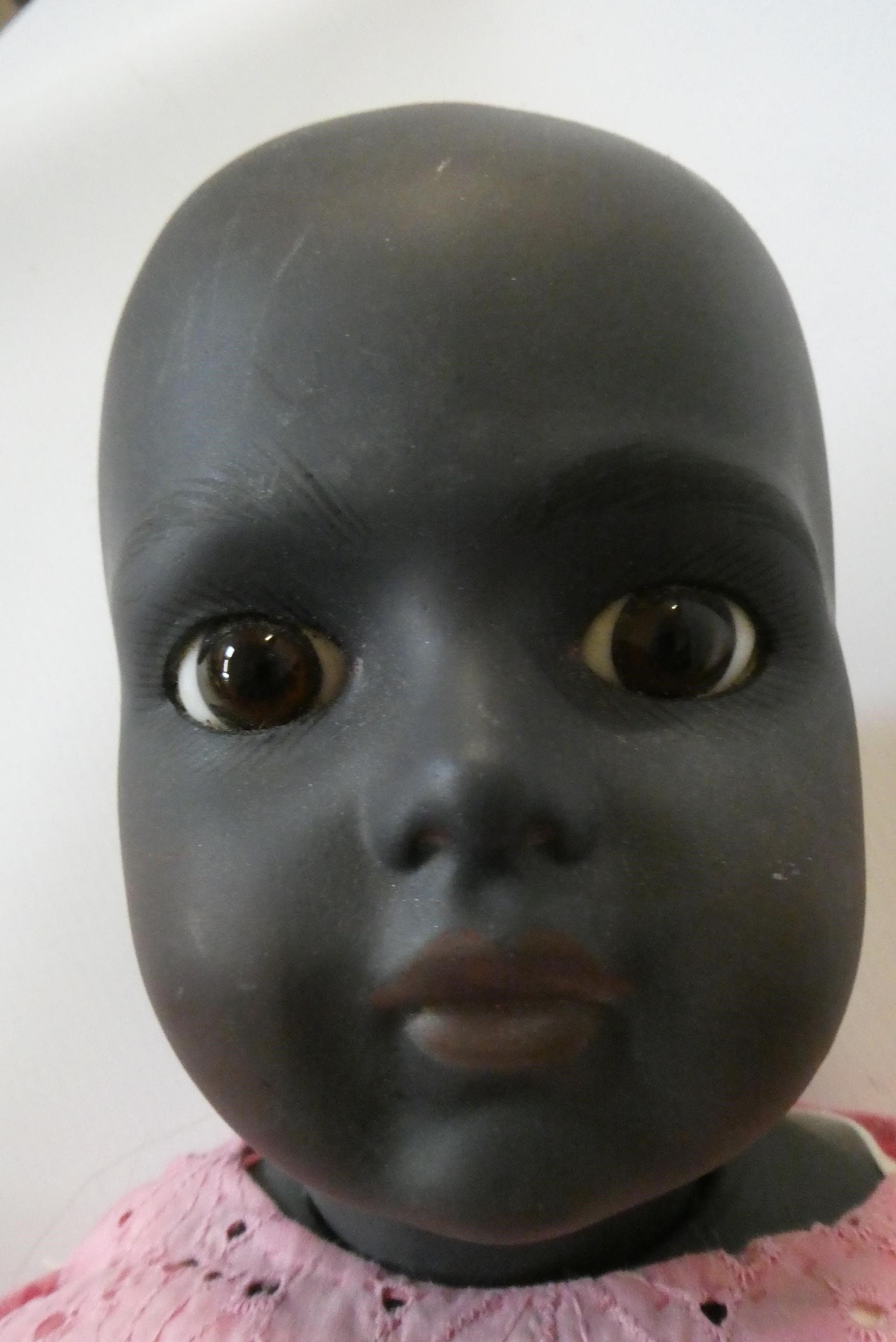 A reproduction Bru bisque socket shoulder head girl doll with brown glass fixed eyes Image