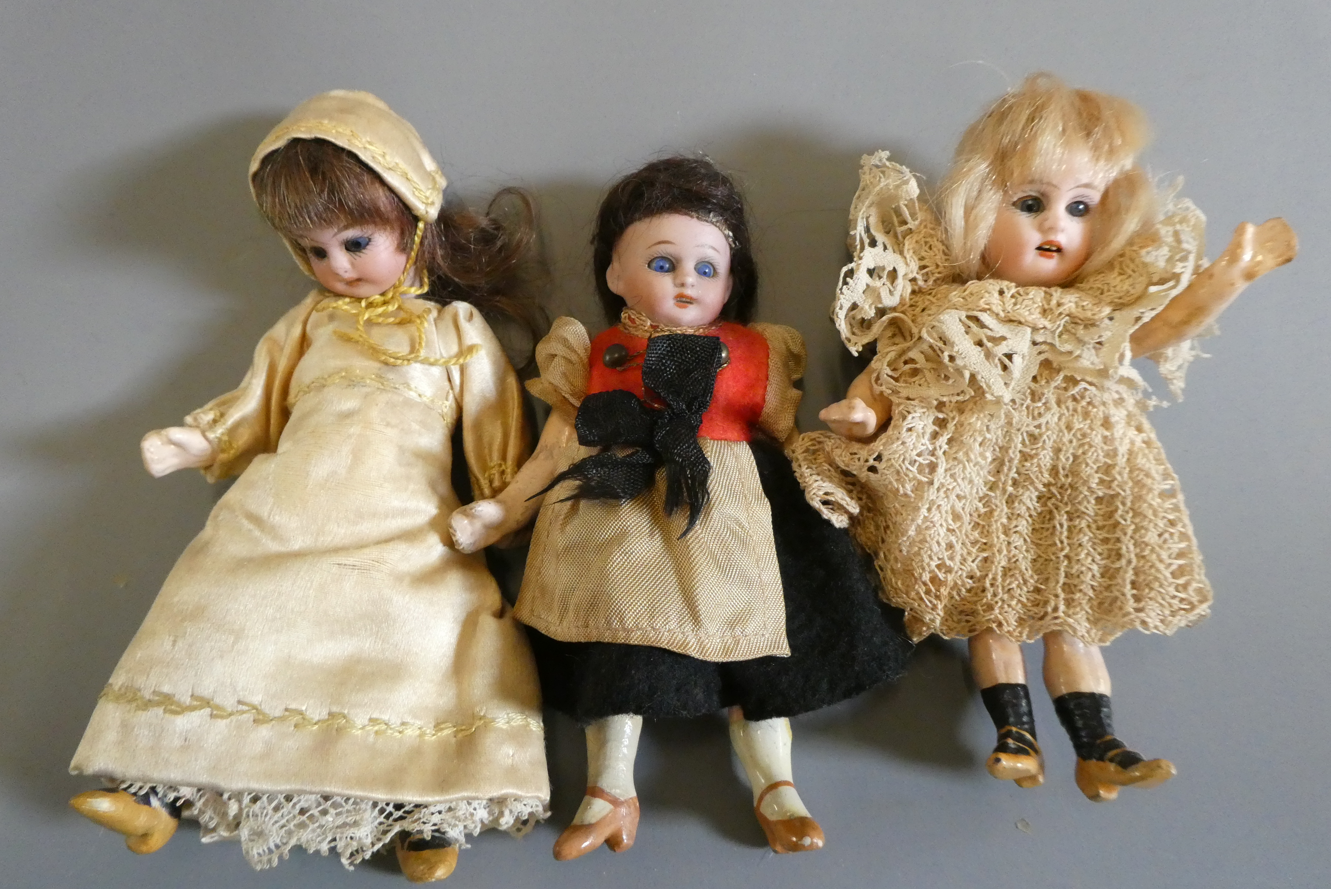 Three bisque socket head doll's house dolls Image