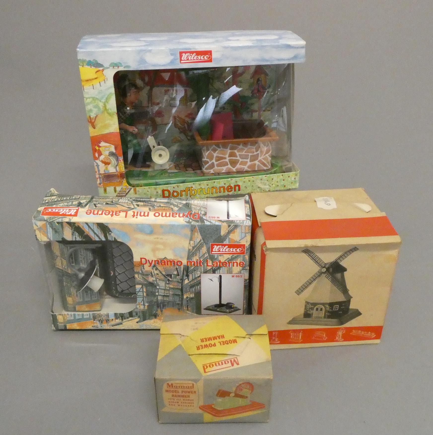 Four stationary steam engine accessories comprising windmill, power hammer, dynamo street light and Image