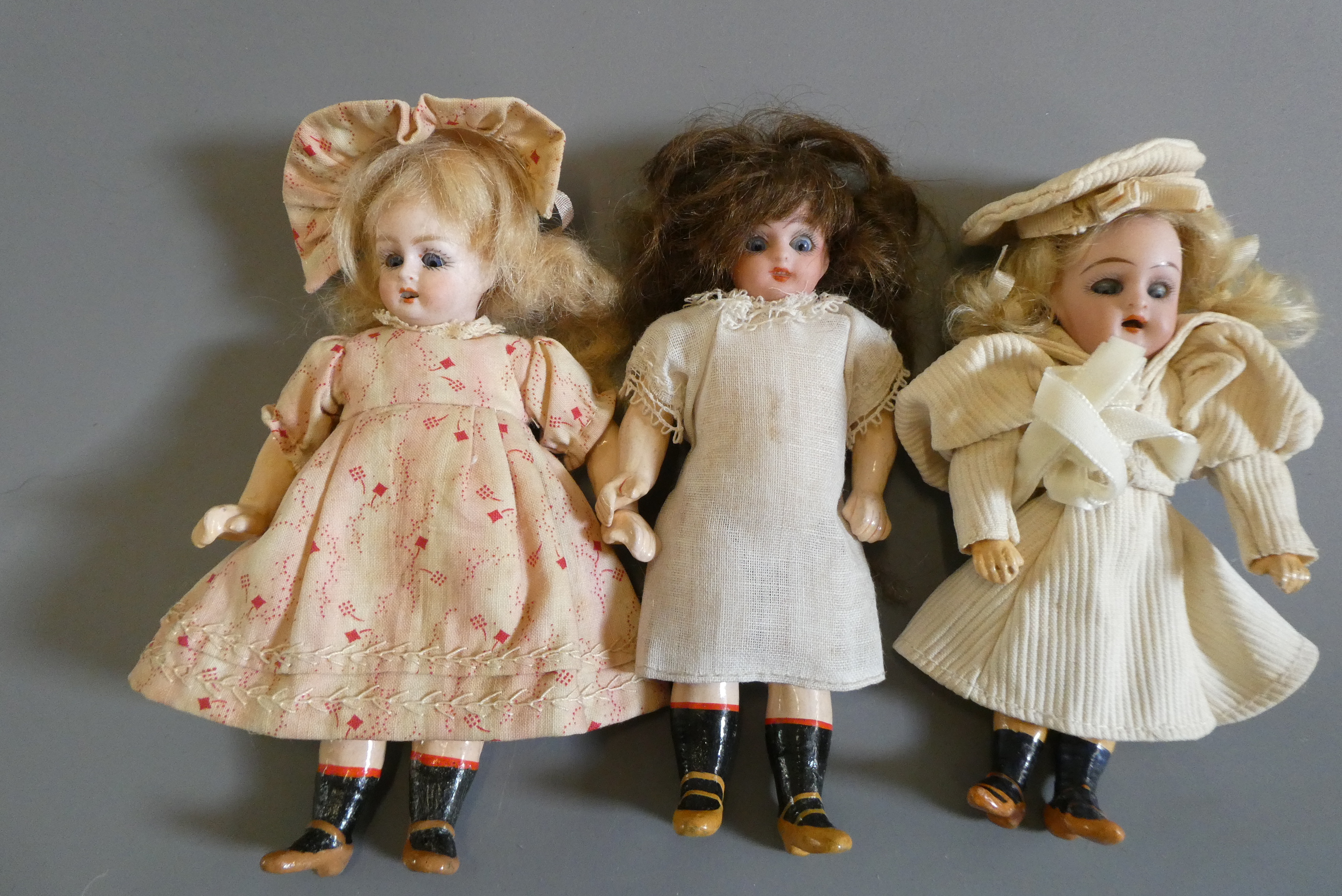 Three bisque socket head doll's house dolls Image