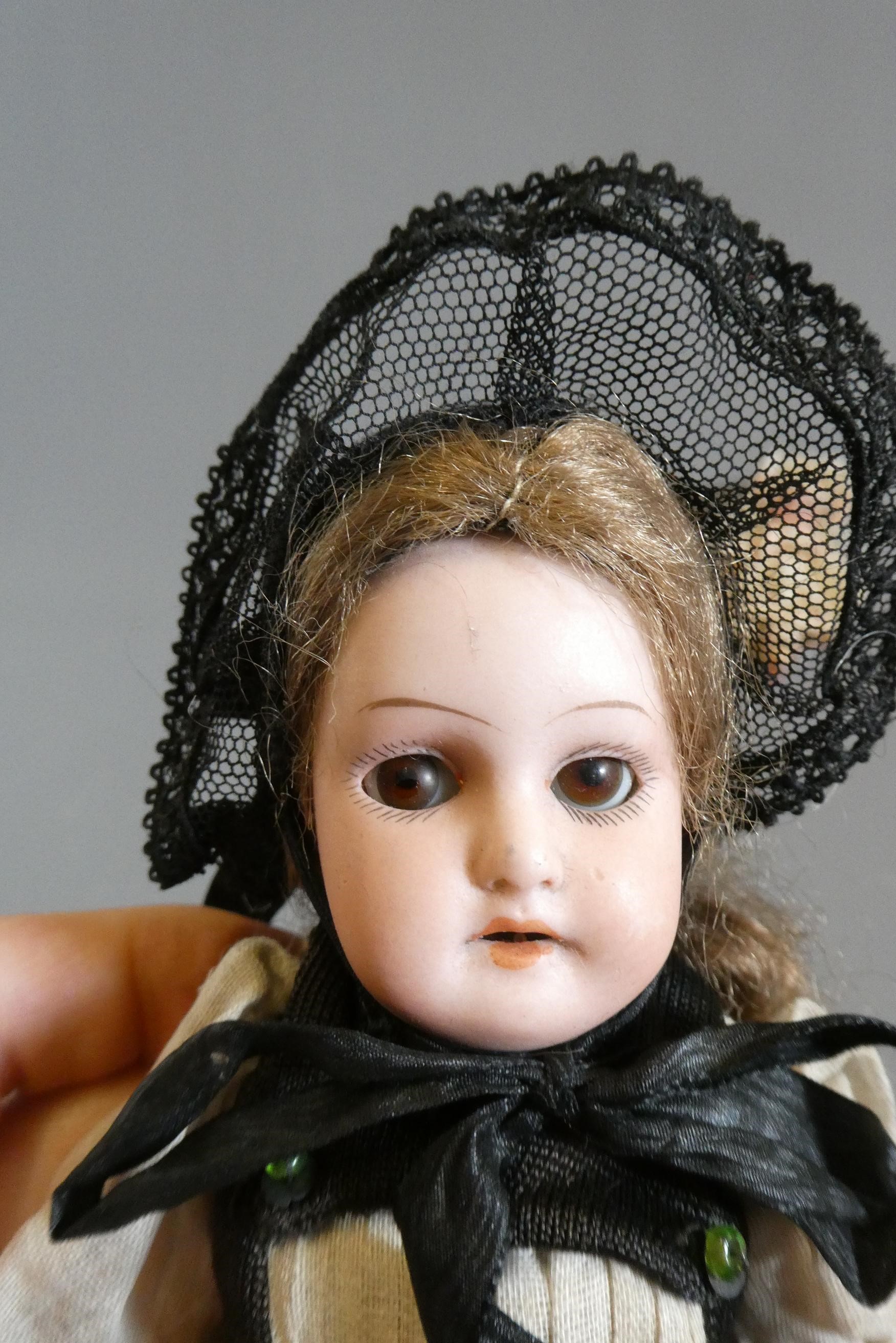 Two small Armand Marseille bisque socket head dolls Image