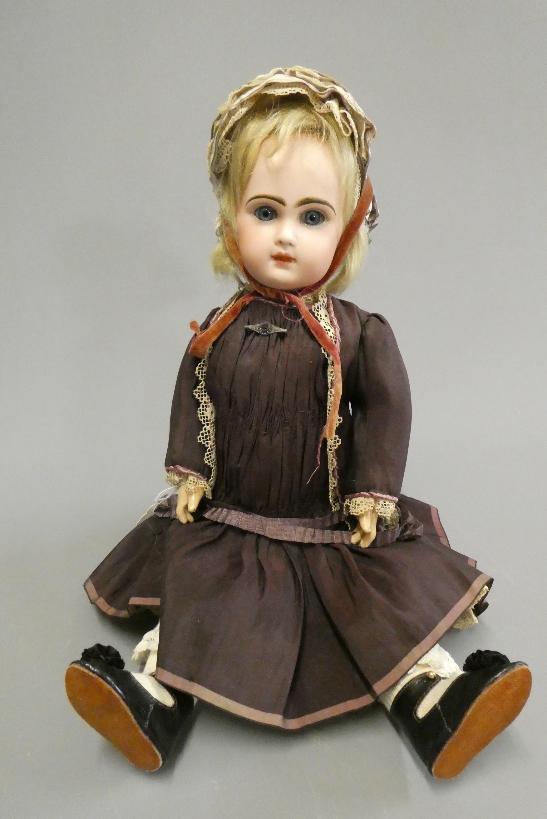 A Tete Jumeau bisque socket head doll with blue glass fixed eyes Image