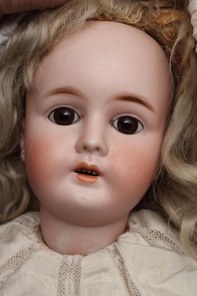 A rare French "Mon Tresor" bisque socket head doll with brown glass fixed eyes Image