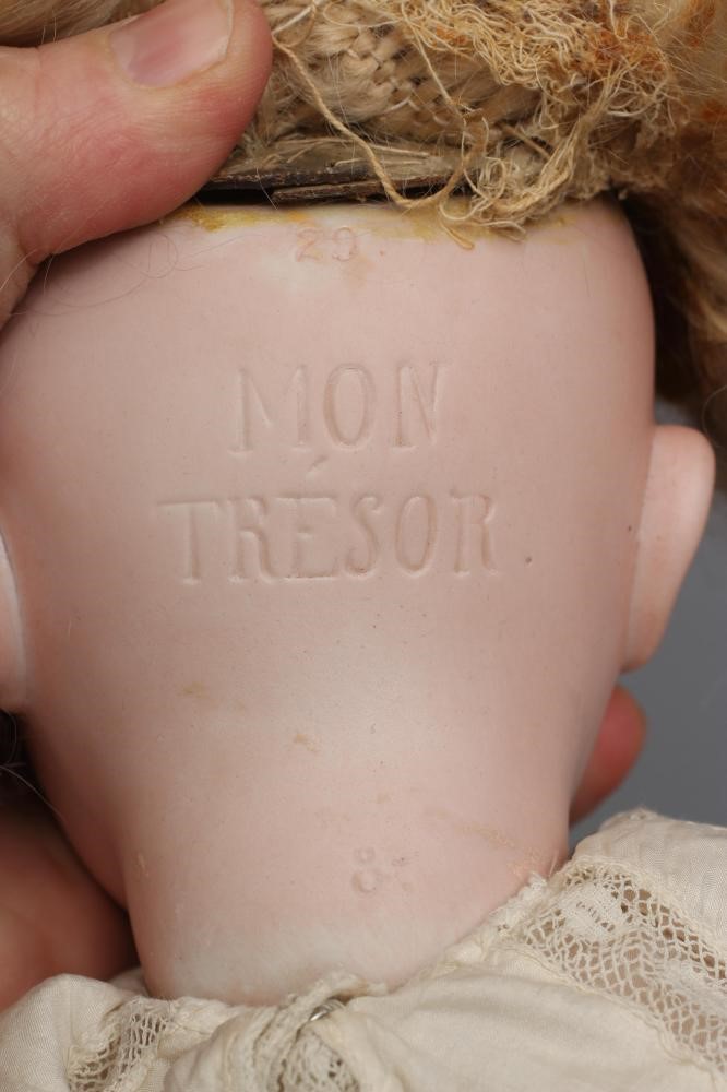A rare French "Mon Tresor" bisque socket head doll with brown glass fixed eyes Image