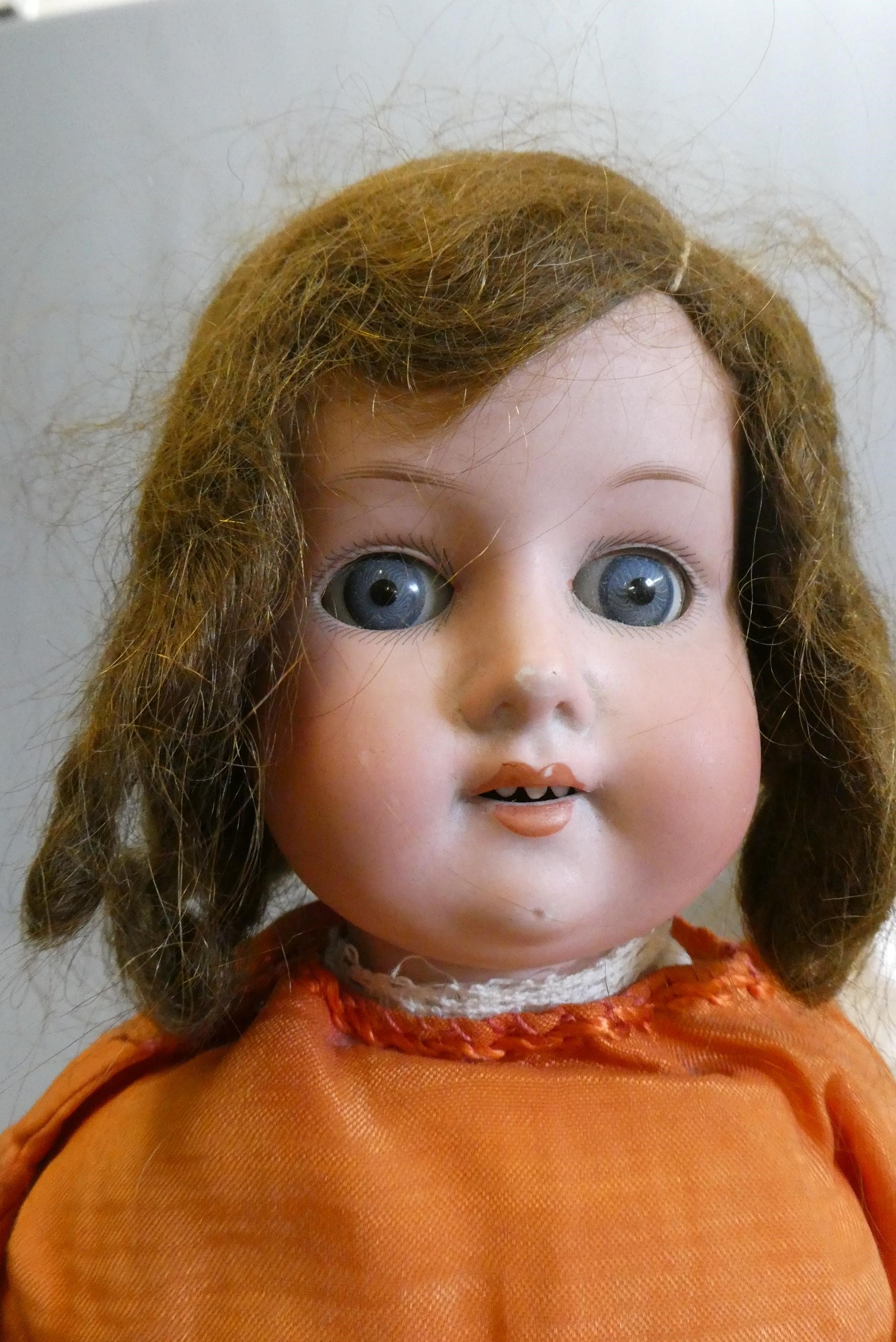 A Max Oscar Arnold bisque socket head doll with blue glass sleeping eyes Image