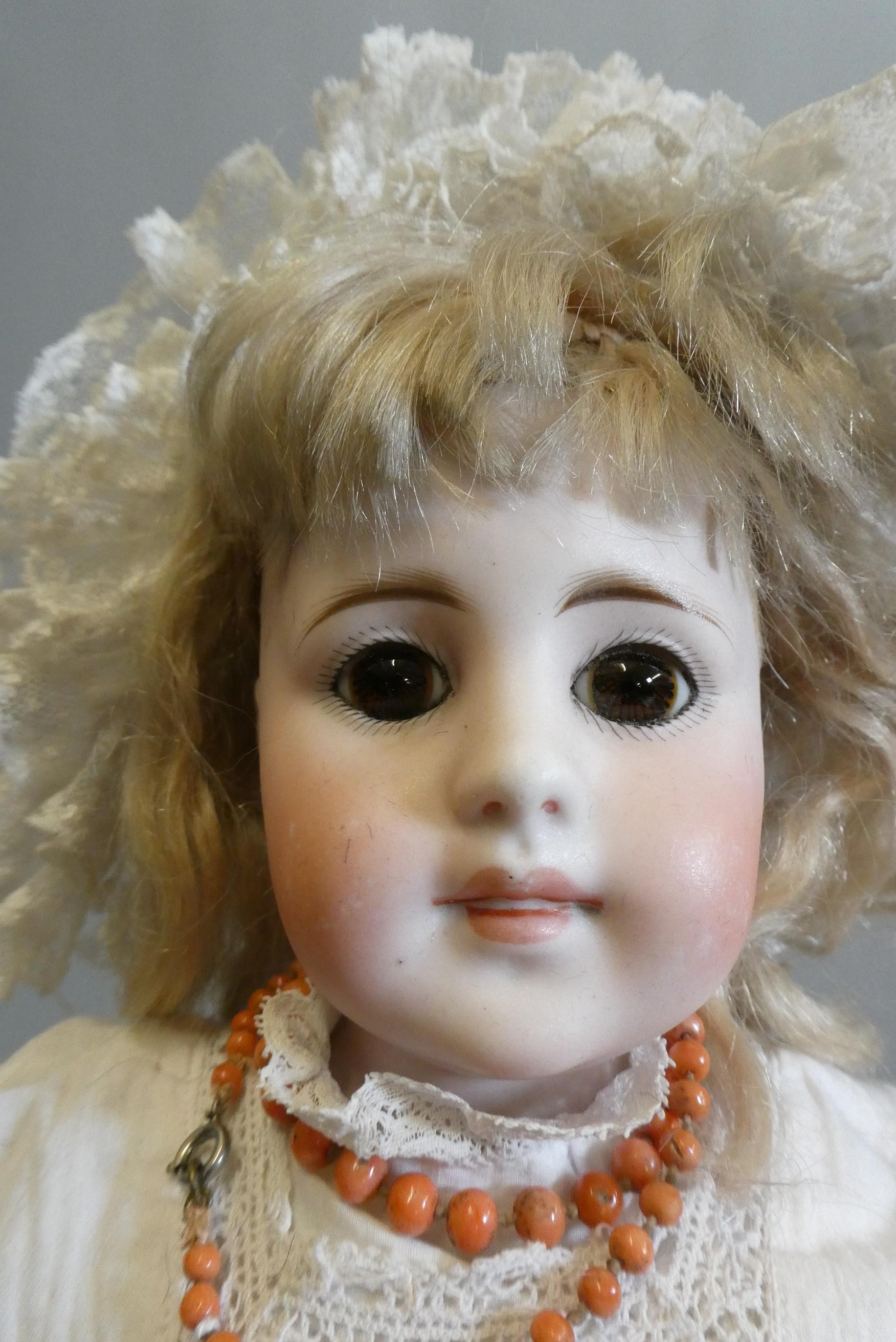 A Max Oscar Arnold bisque socket head doll with blue glass sleeping eyes Image