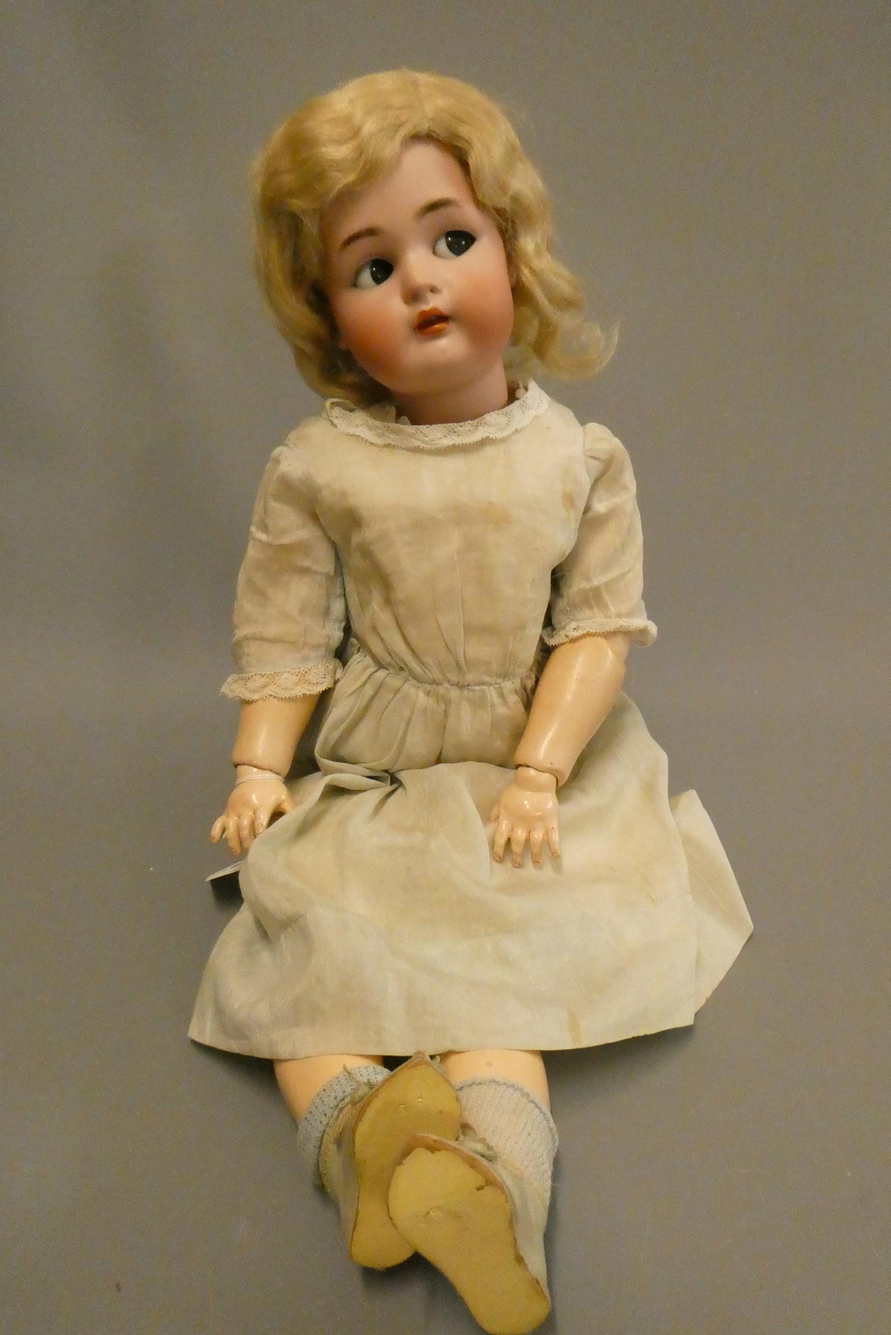 A Simon & Halbig Kammer & Reinhardt bisque socket head doll with brown glass sideways glancing eyes Image