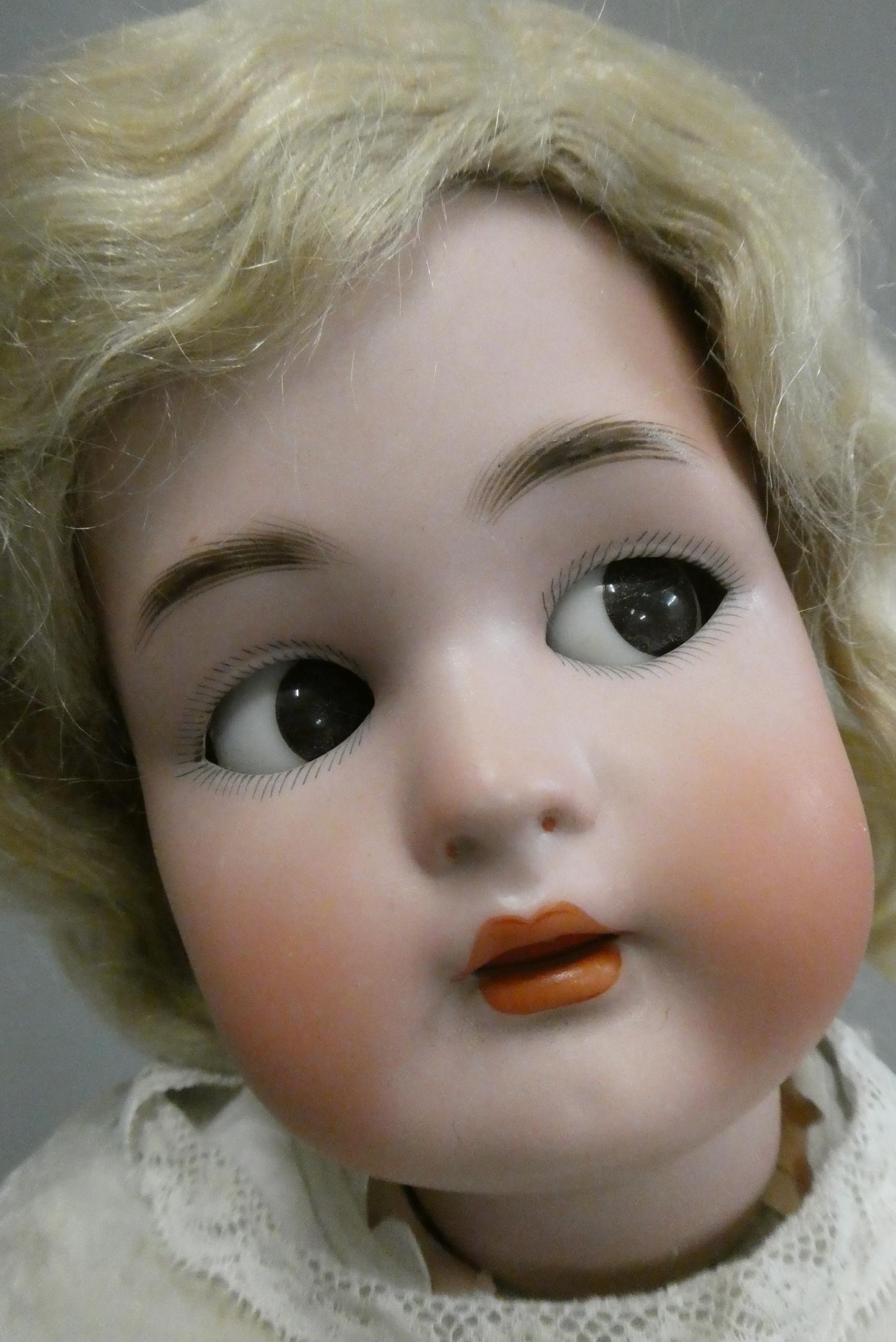 A Simon & Halbig Kammer & Reinhardt bisque socket head doll with brown glass sideways glancing eyes Image