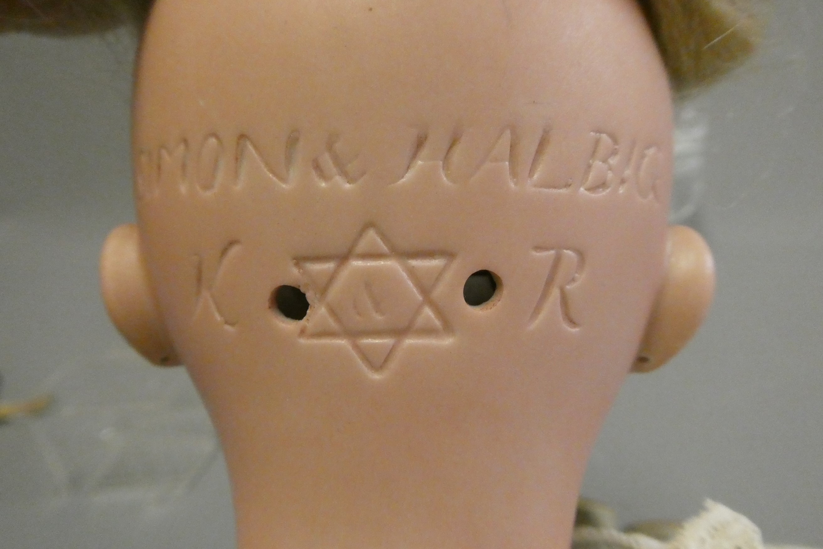 A Simon & Halbig Kammer & Reinhardt bisque socket head doll with brown glass sideways glancing eyes Image