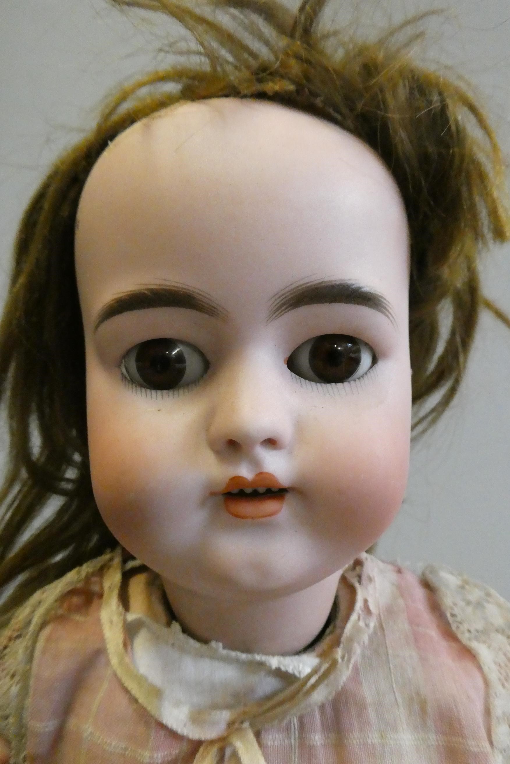 A Simon & Halbig bisque socket head doll with head turning mechanism Image