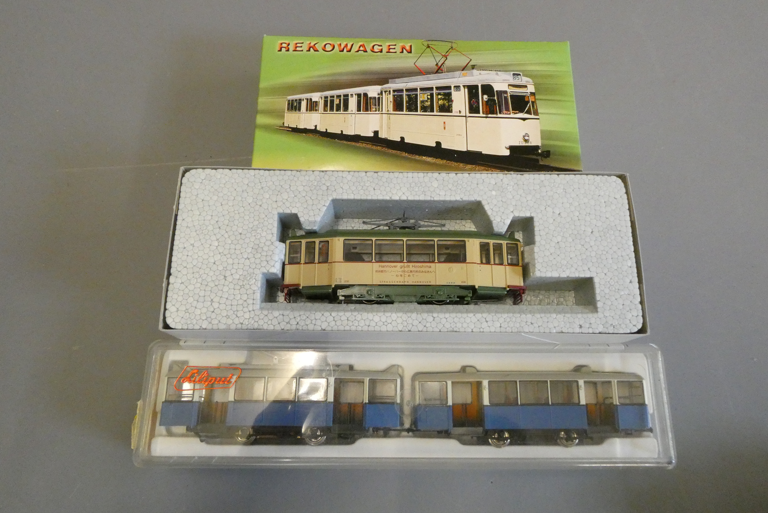 Three HO scale 12 volt 2-rail European trams by Kato, Lilliput and REKO, all items boxed, excellent Image