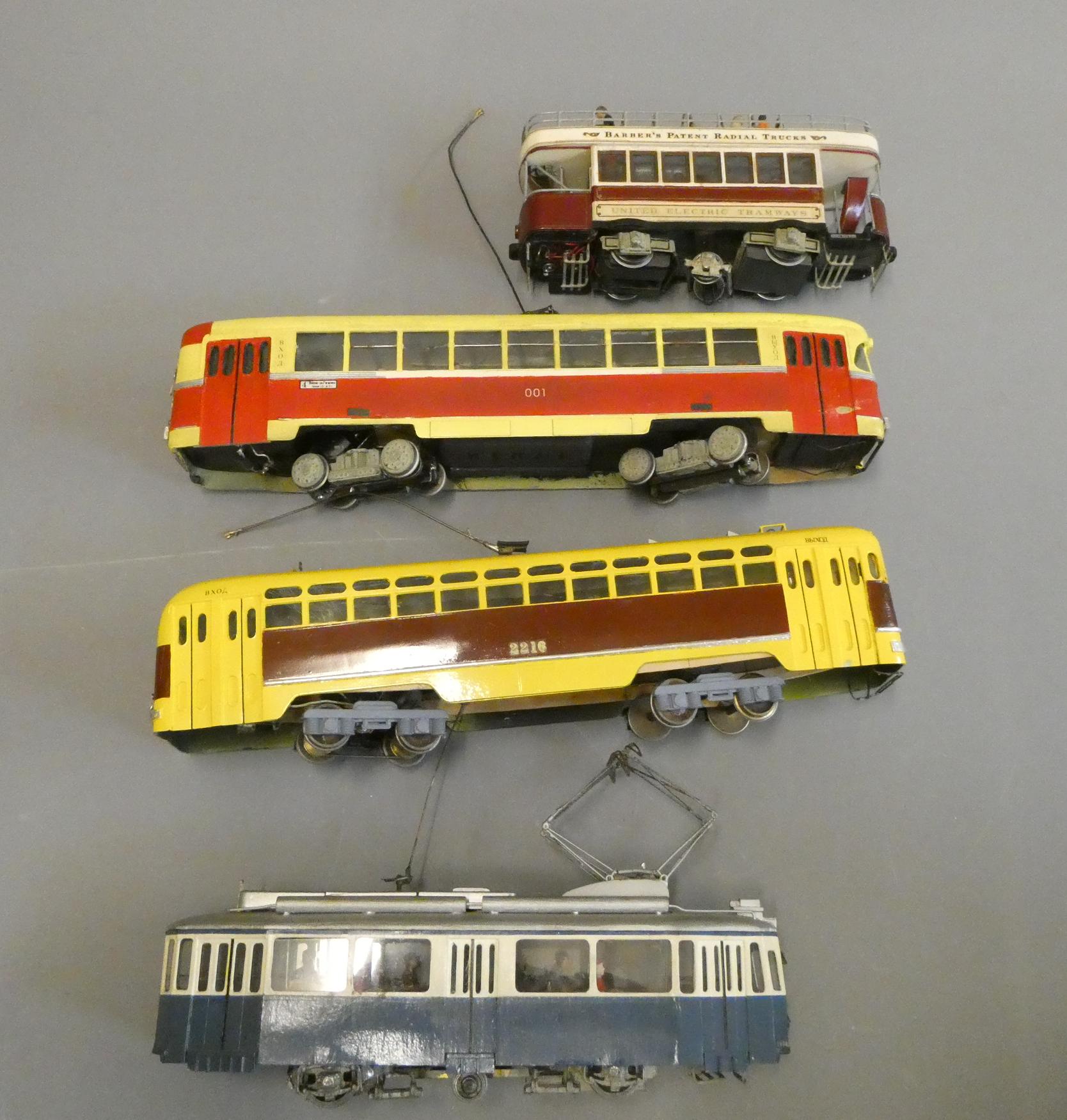 Four O gauge 12 volt 2-rail tram models comprising three European types and a British open top tram. Image
