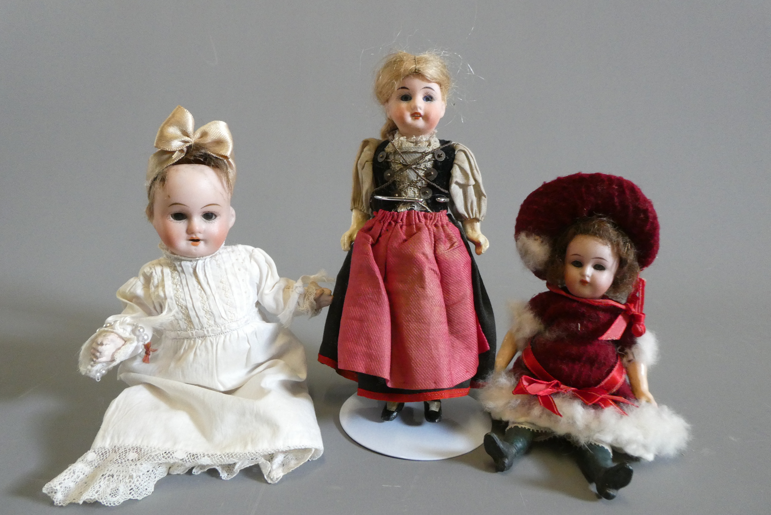 Three small bisque socket head dolls Image