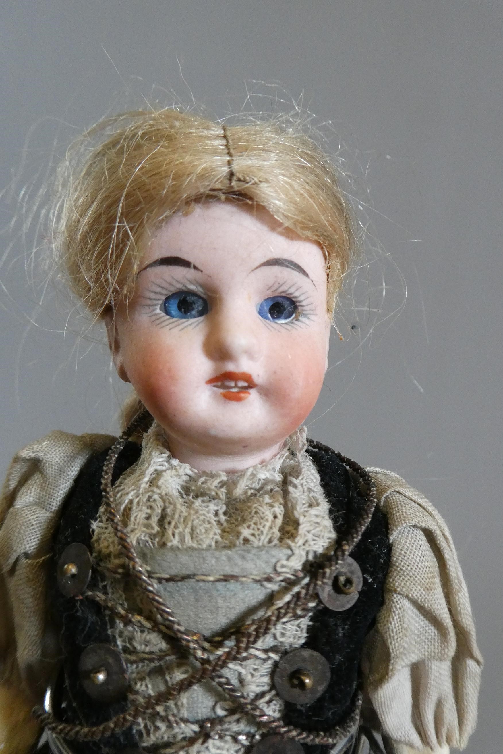 Three small bisque socket head dolls Image