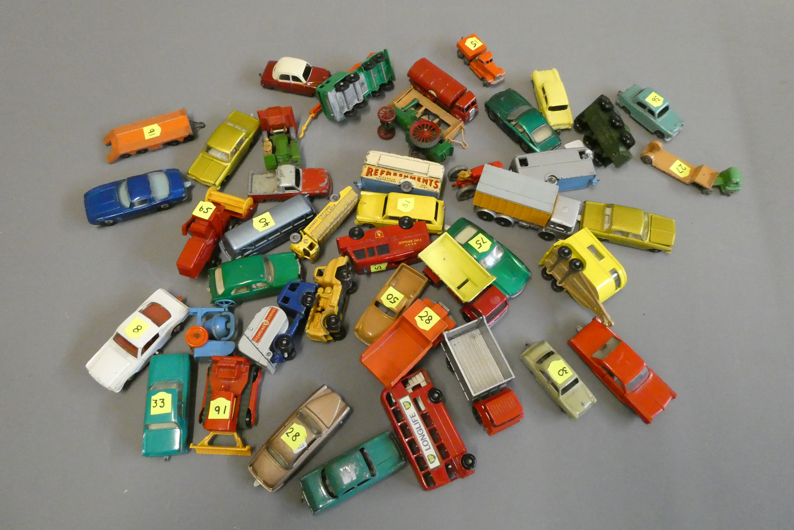 Unboxed Matchbox cars including saloon cars, buses and trucks, some items have paint loss or parts Image