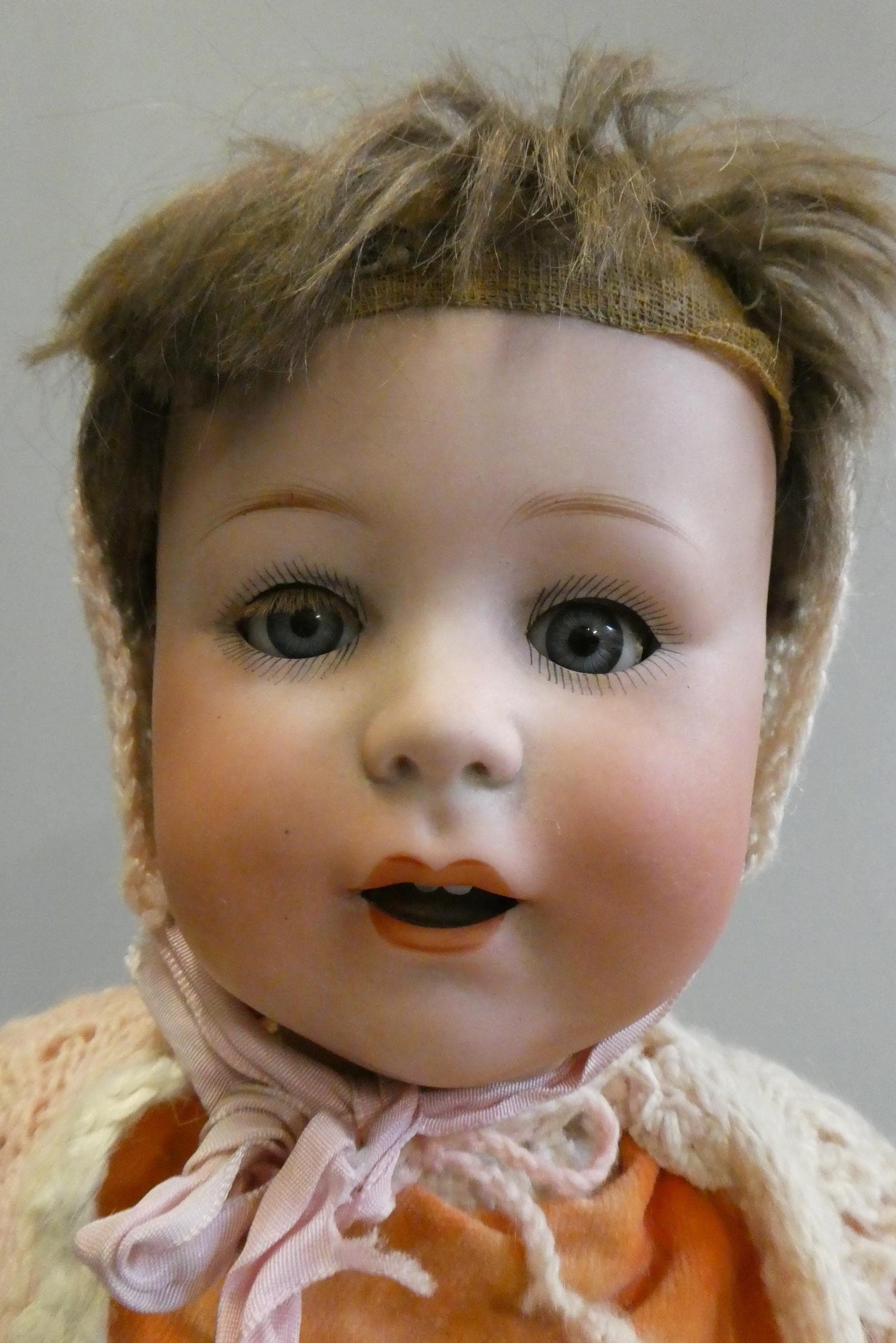 A Jutta bisque socket head doll with blue glass sleeping eyes Image
