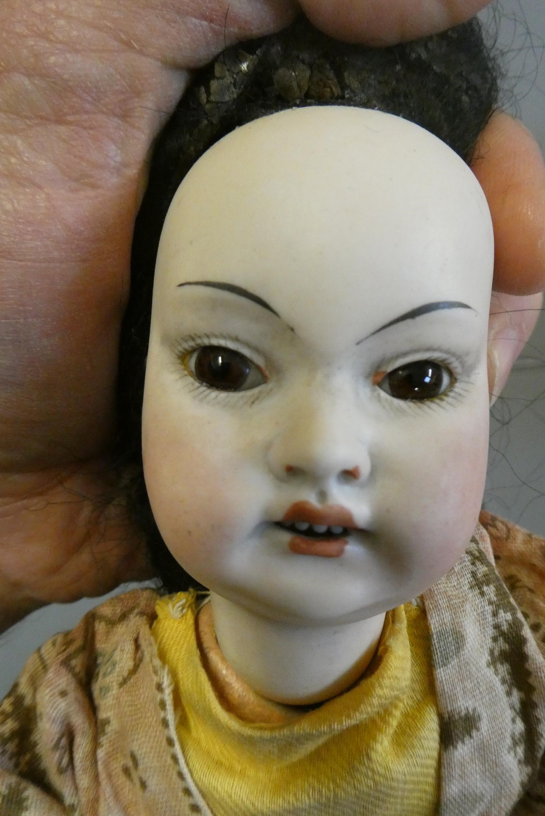 A rare Armand Marseille Japanese socket head doll with brown glass fixed eyes Image