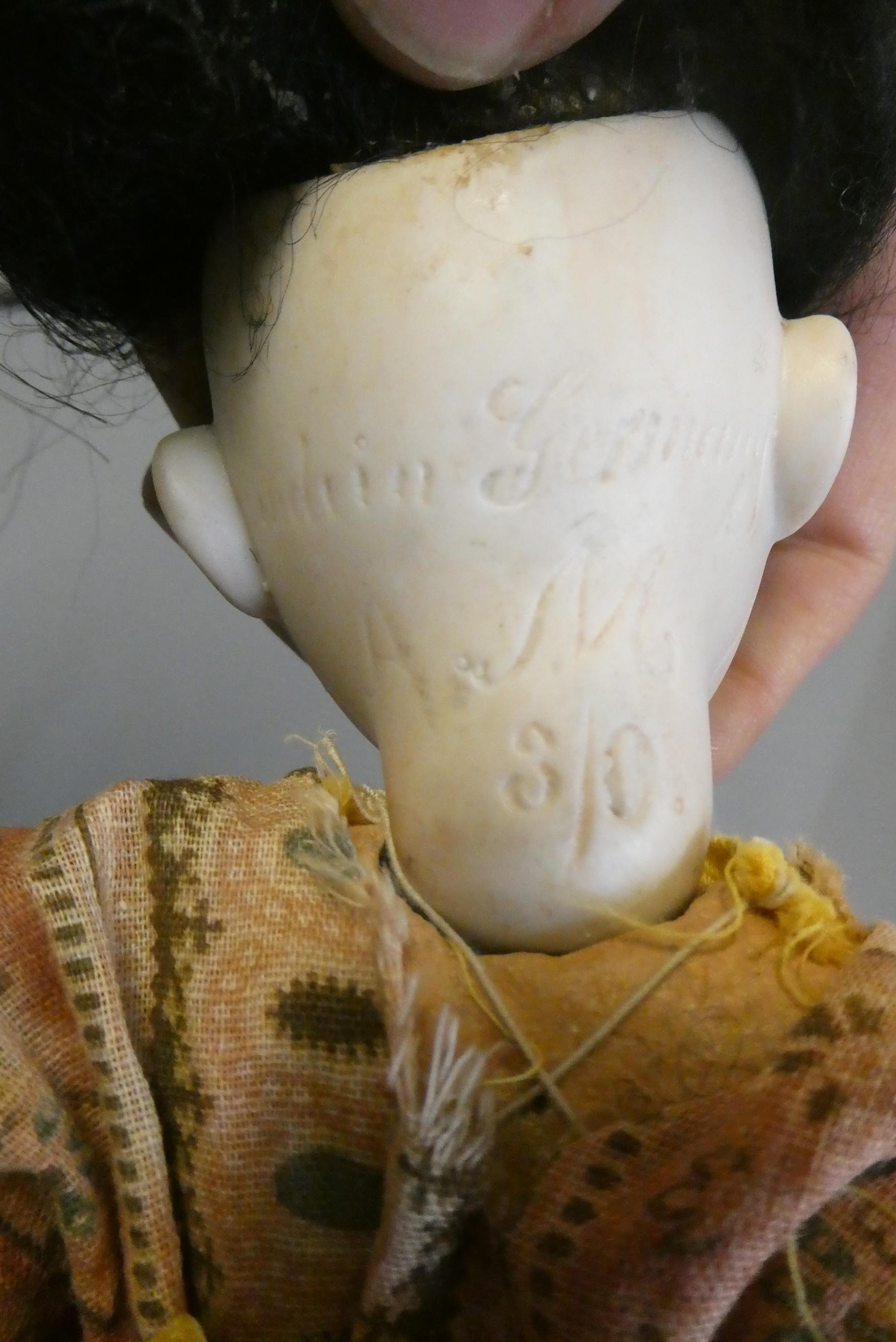 A rare Armand Marseille Japanese socket head doll with brown glass fixed eyes Image